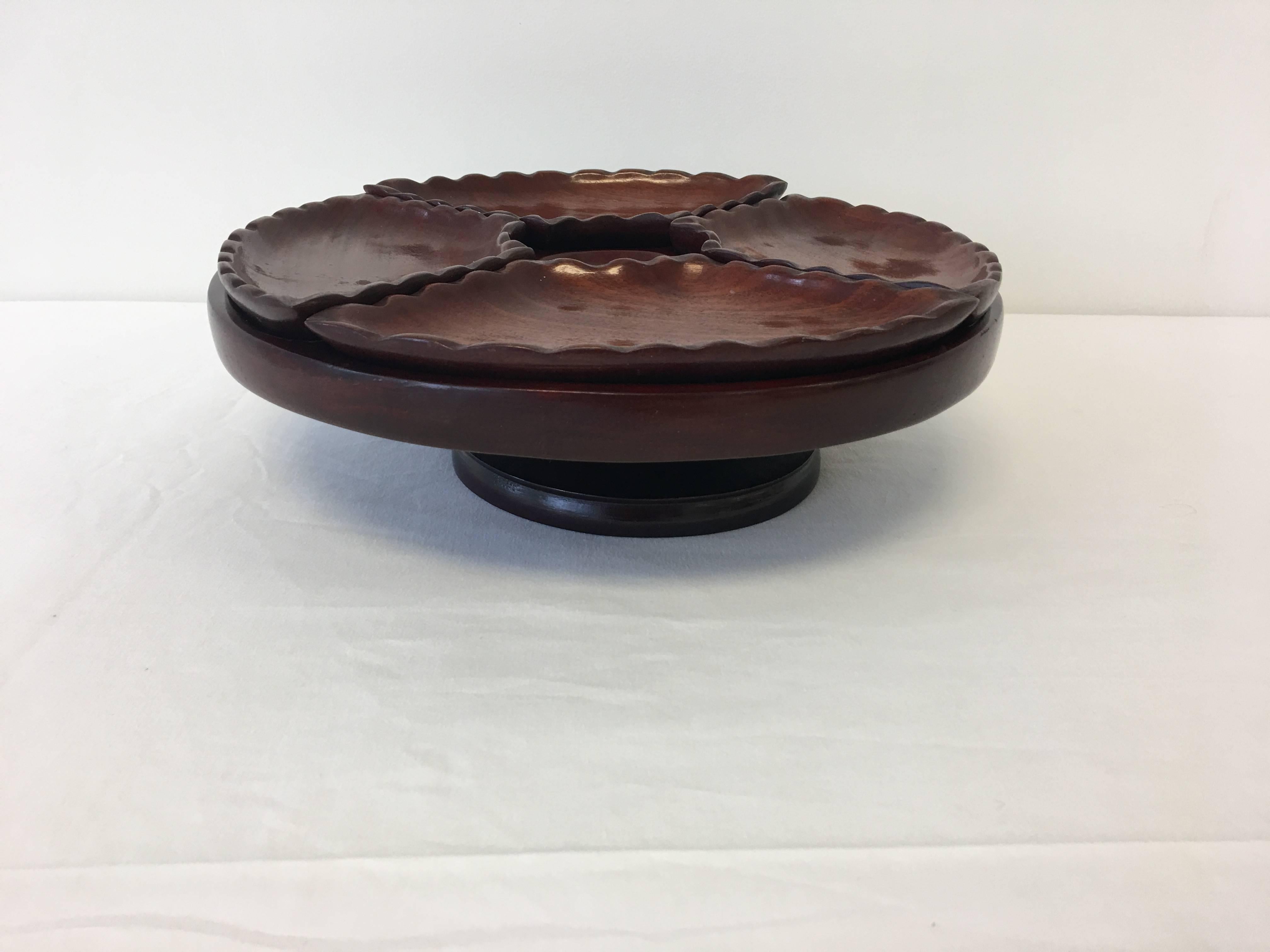Offered is a fabulous, 1950s Mid-Century Modern rosewood pedestal five-piece serving tray. Includes four dishes and one rotating pedestal.

Each dish measures: 1