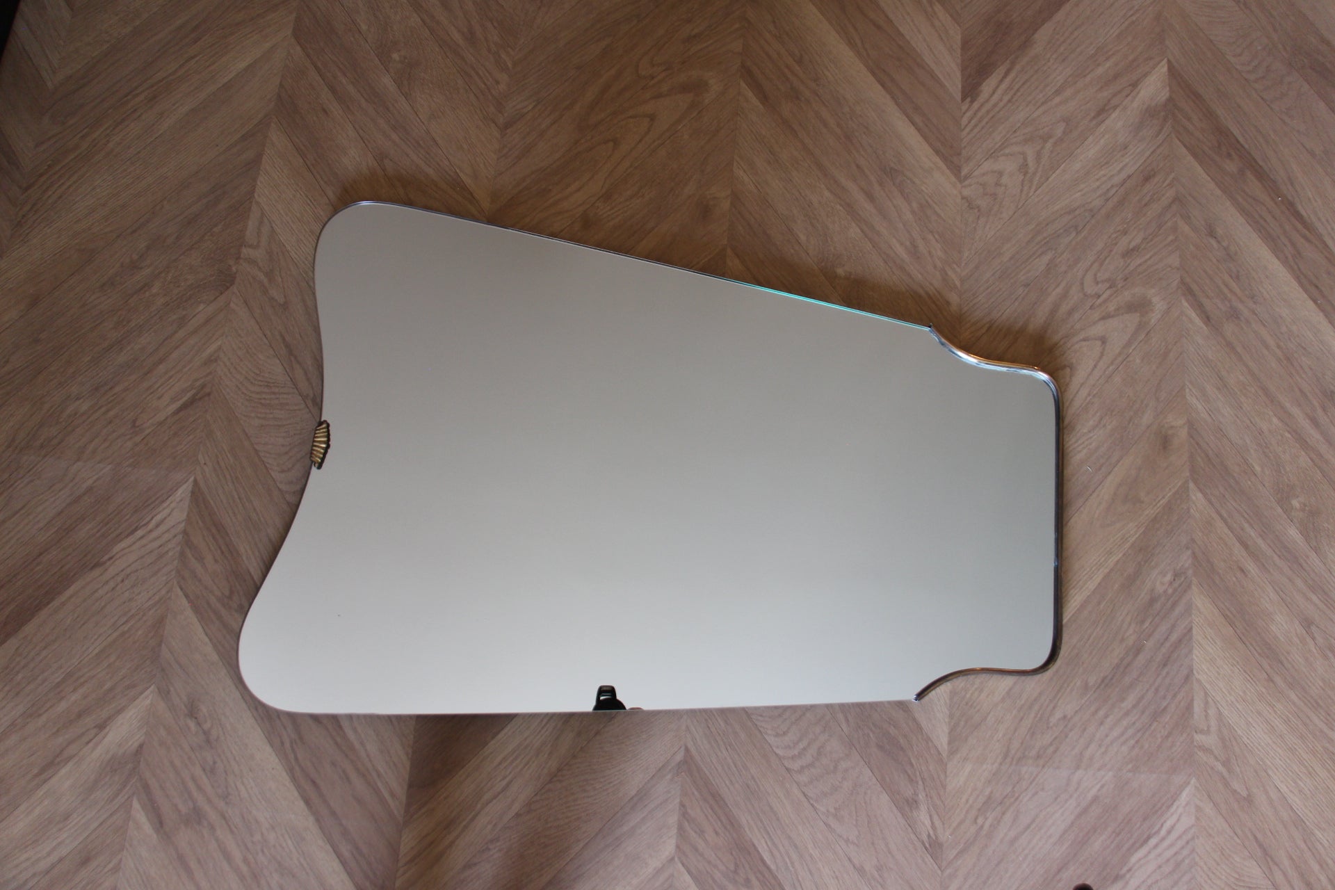 This very decorative mirror was made in Italy in 1950s. It is typical of this period design and is all original. 
It could be hanged upon a wall on its own or mixed with other same style mirrors to get a spectacular look.
Its brass frame is thick