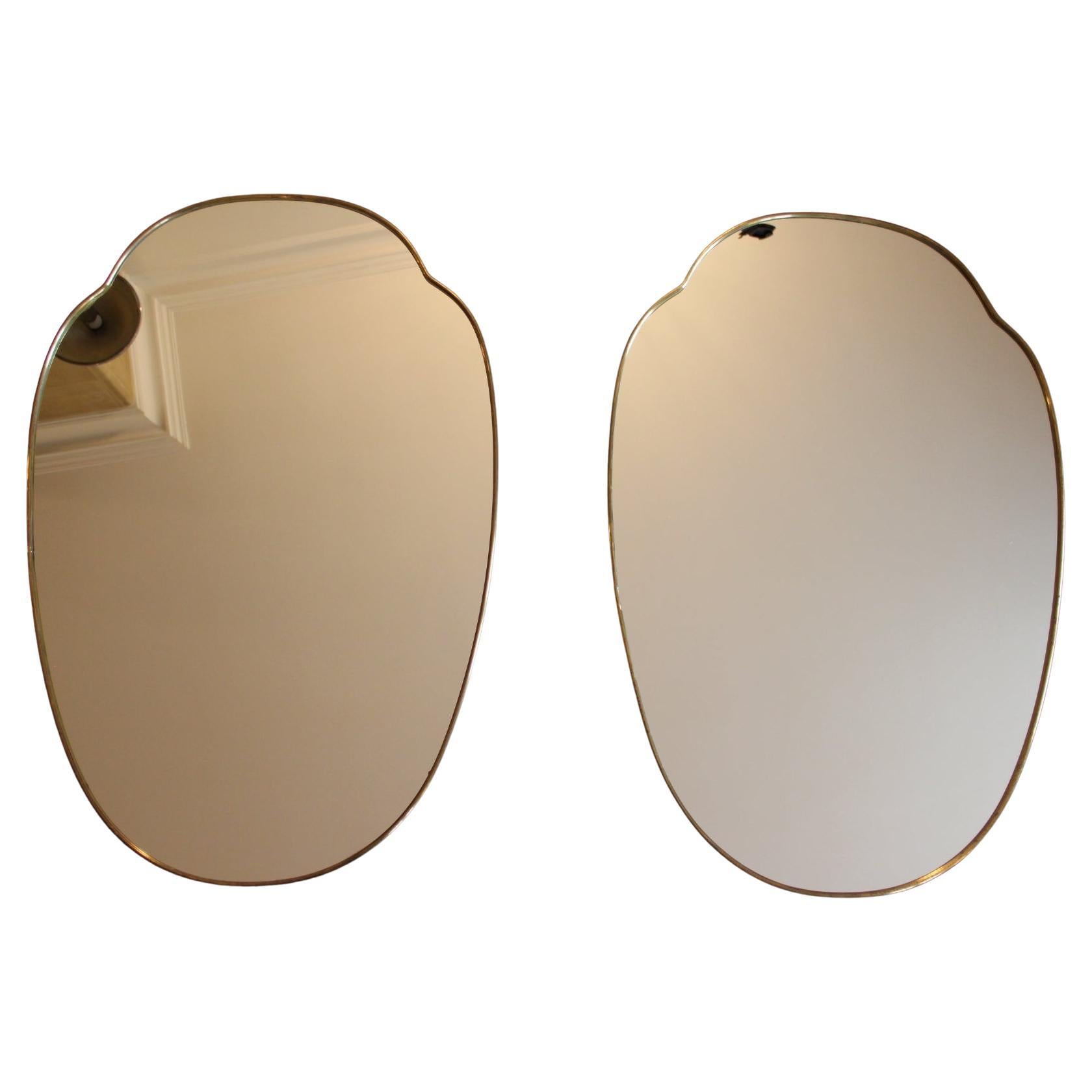 These very decorative mirrors were made in Italy in 1950s. It is typical of this period design and is all original. 
It could be hanged upon a wall on its own or mixed with other same style mirrors to get a spectacular look.
Its brass frame is thick