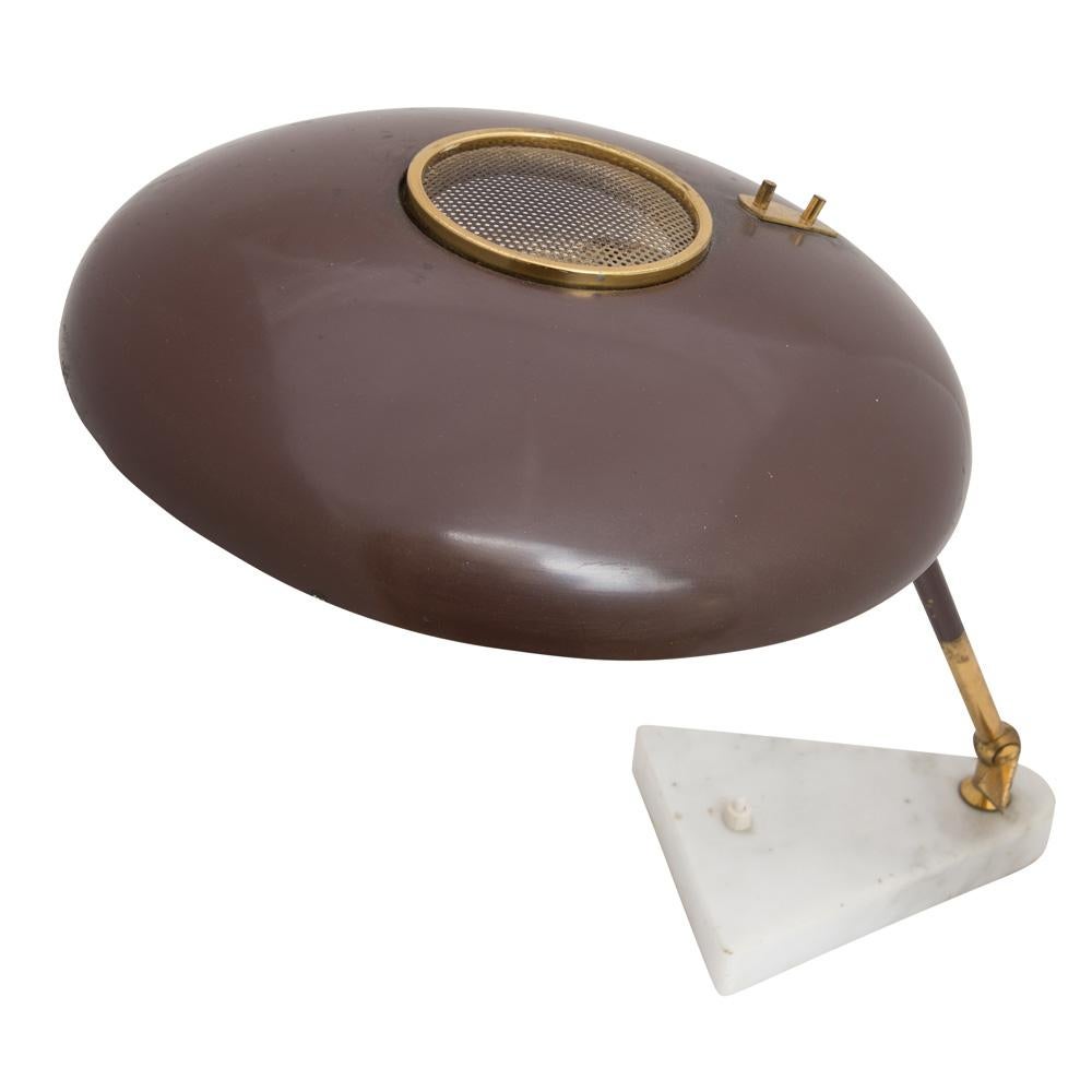 A 1950s Italian design desk/table light with a lot of style.
Round shaped chocolate brown enamelled metal shade with a tubular brass structure on a white marble base. Designed Oscar Torlasco for Stilux Milano Italy.
This lamp would look amazing in
