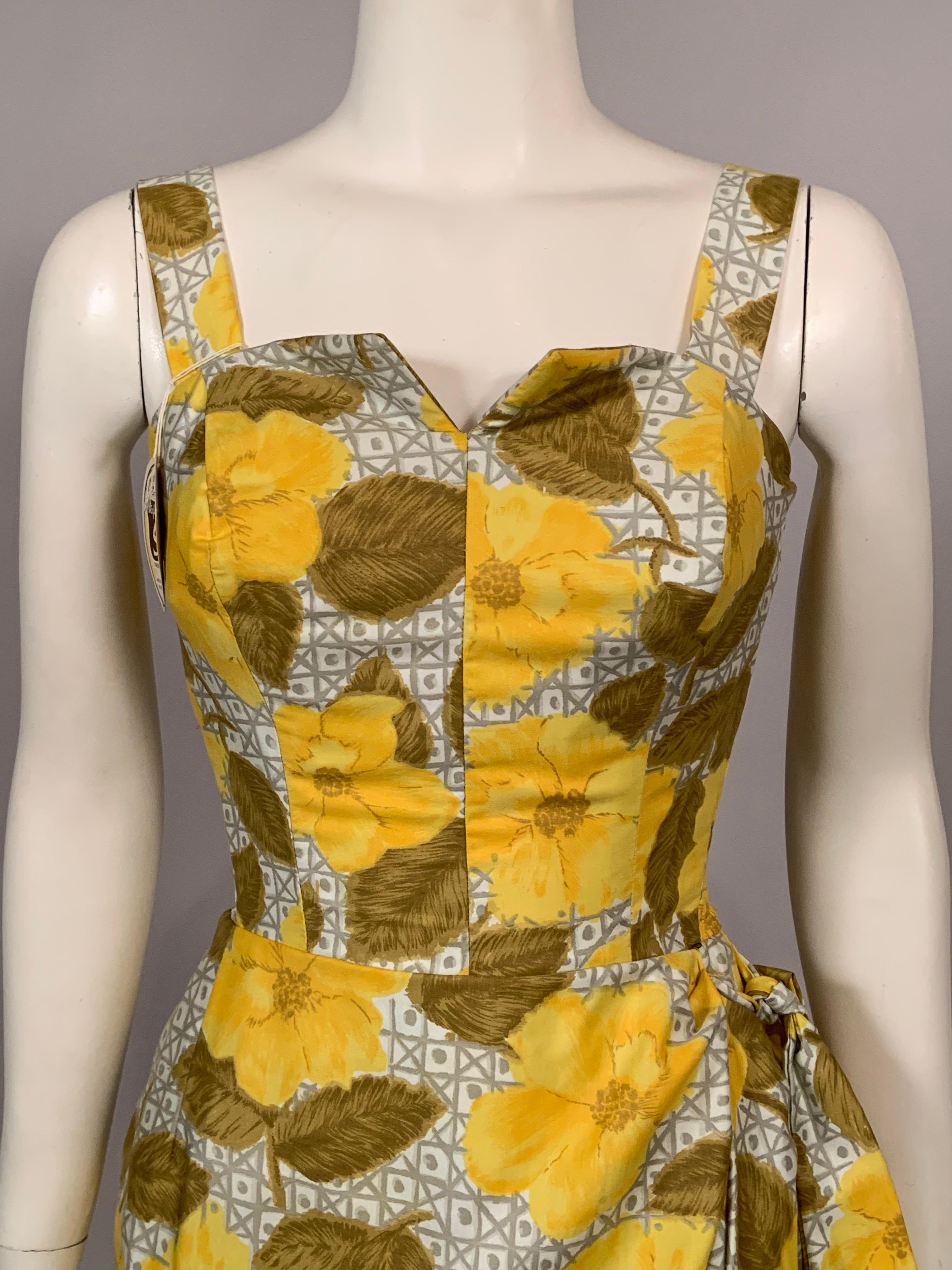 A cheerful yellow flower print on a grey and white lattice print background is used for this cotton beach dress from the 1950's by Modi of Miami. The dress has a boned bodice, adjustable straps, elasticized side panels, an attached faux wrap skirt,