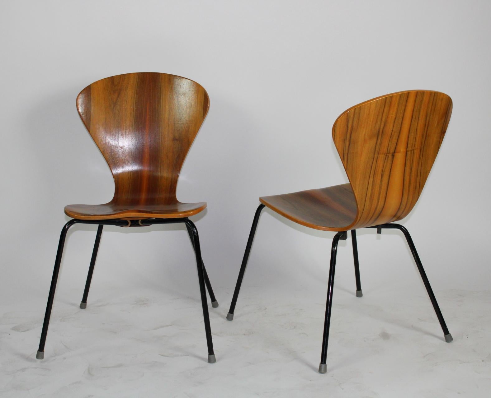 Gorgeous set of 4 molded plywood chairs with exotic wood grain, 
circa 1950s. Black enameled legs. Stackable and extremely comfortable.