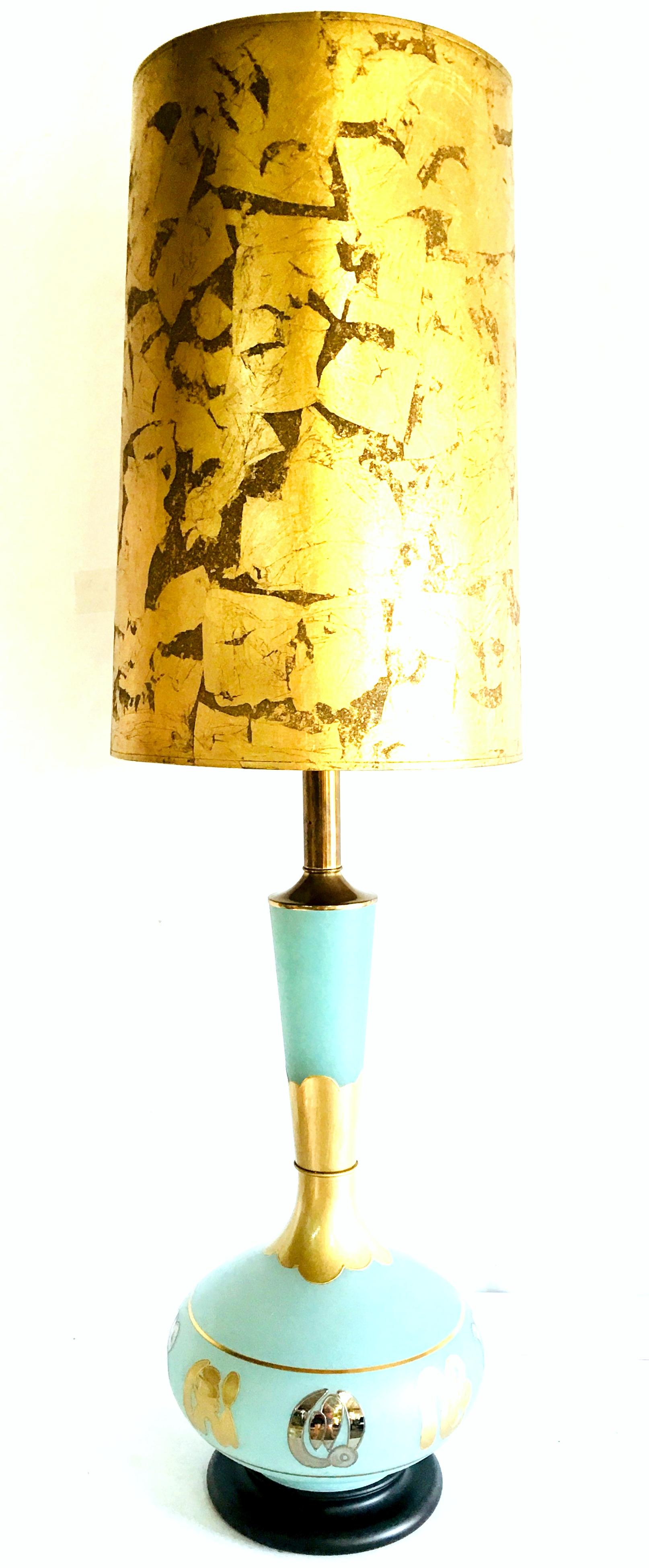 Mid-20th Century monumental hand blown glass, frosted sea foam green with silver and gold gilt Arabesque style table lamp. This sea foam green frosted art glass lamp features hang painted applied silver and gold gilt arabesque symbol motifs. The