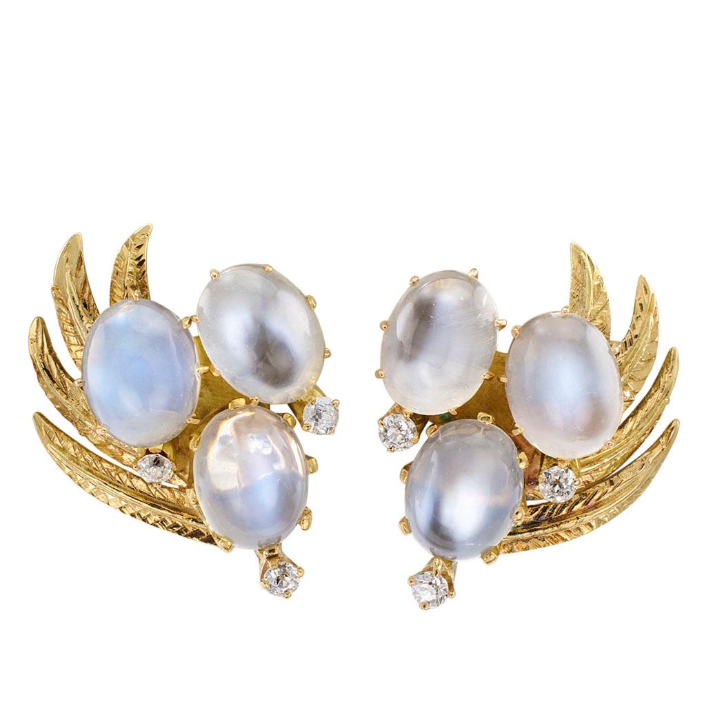Moonstone and diamond gold ear clips circa 1950. The left and right matching designs feature trios of luminous moonstones and sparkling diamonds arranged over a spray of gold leaves motif, mounted in 14-karat gold. These earrings are a smart size,