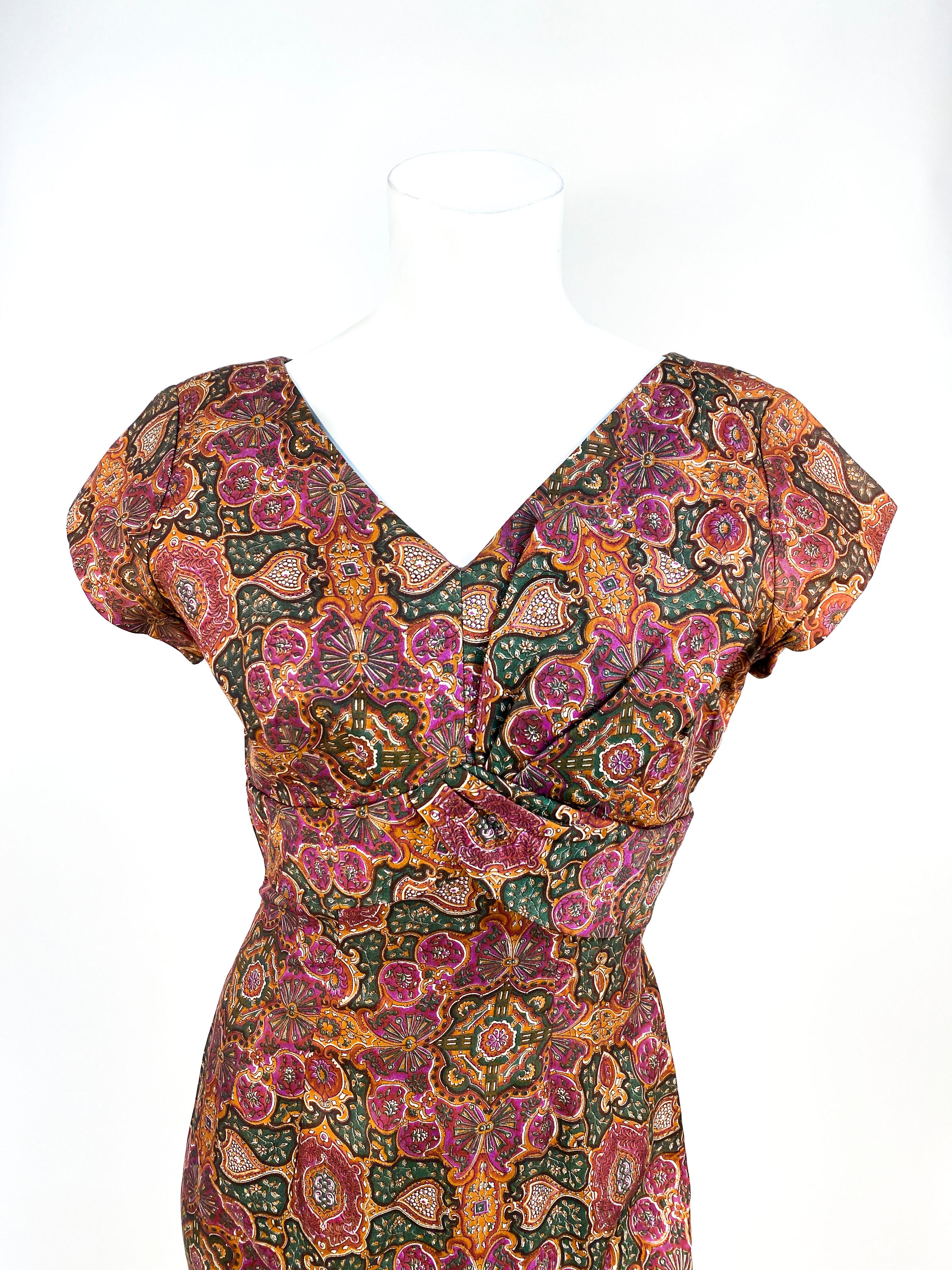 1950s Mosaic Printed Cocktail Dress with empire bust line, sash decoration on one side, cap sleeves, and darting. The back has a metal zip closure.