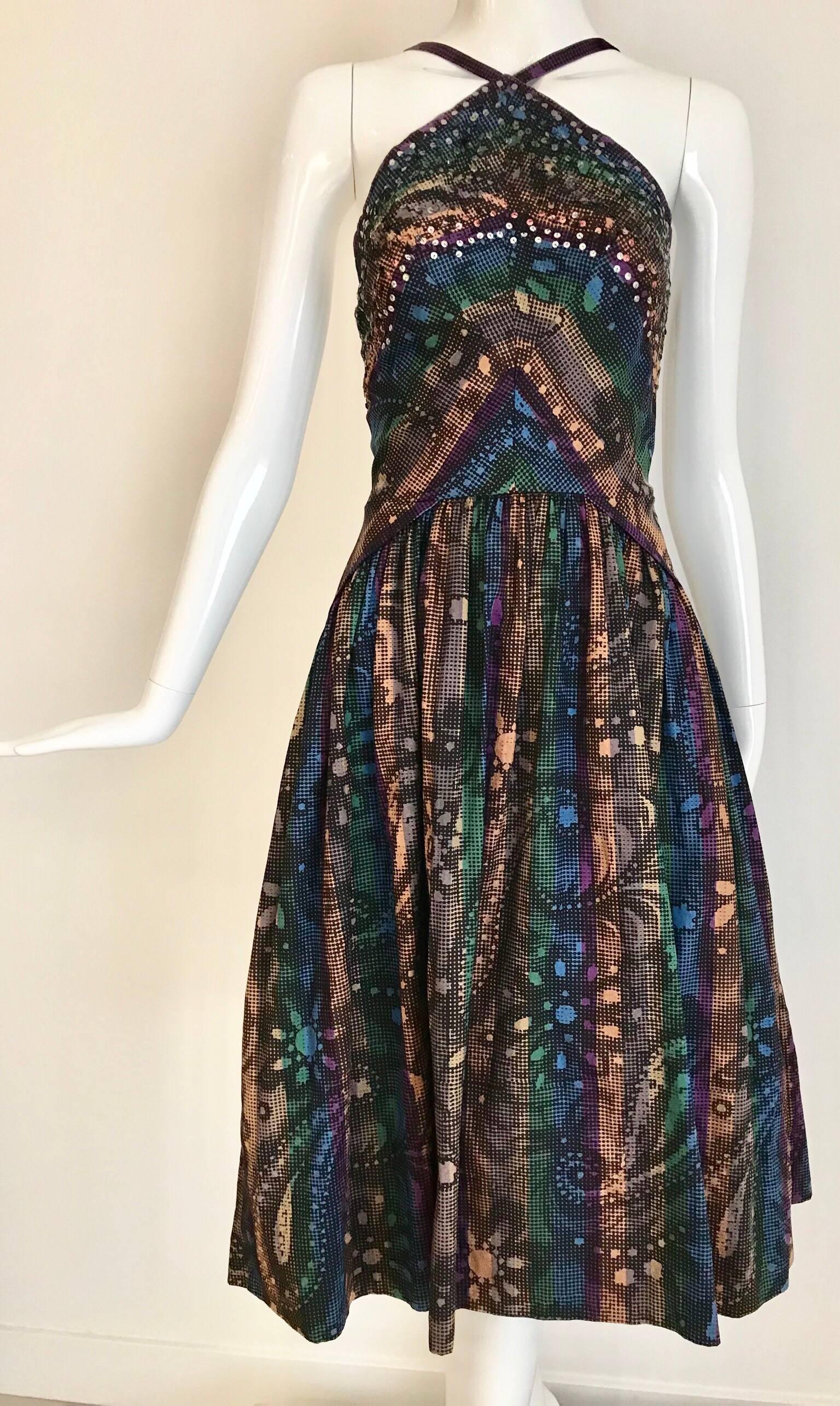 What a fun 1950s cocktail dress! Sexy Halter style with multi color print in purple, blue, green, creme, light orange and sequins.  Fitted at the waist with crinoline underneath.
Bust: 32