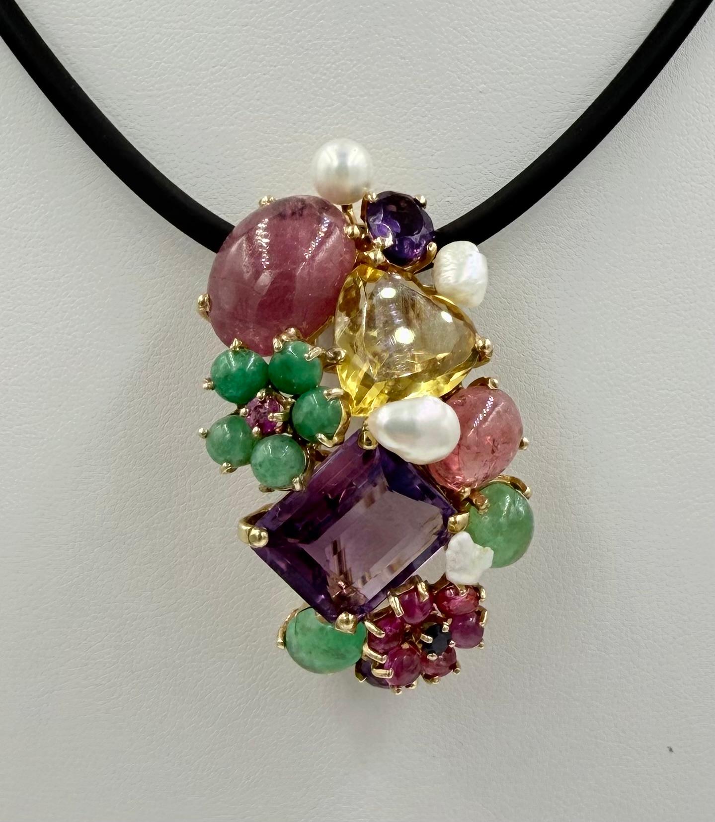 1950s Multi Gem 14k Yellow Gold Brooch Pendant.

The Multi-Gem and 14k Yellow Gold Brooch Pendant was made around the 1950s.  All hand assembled, this one of a kind brooch pendant is set with multi colored gemstones and pearls.  It is quite unique. 