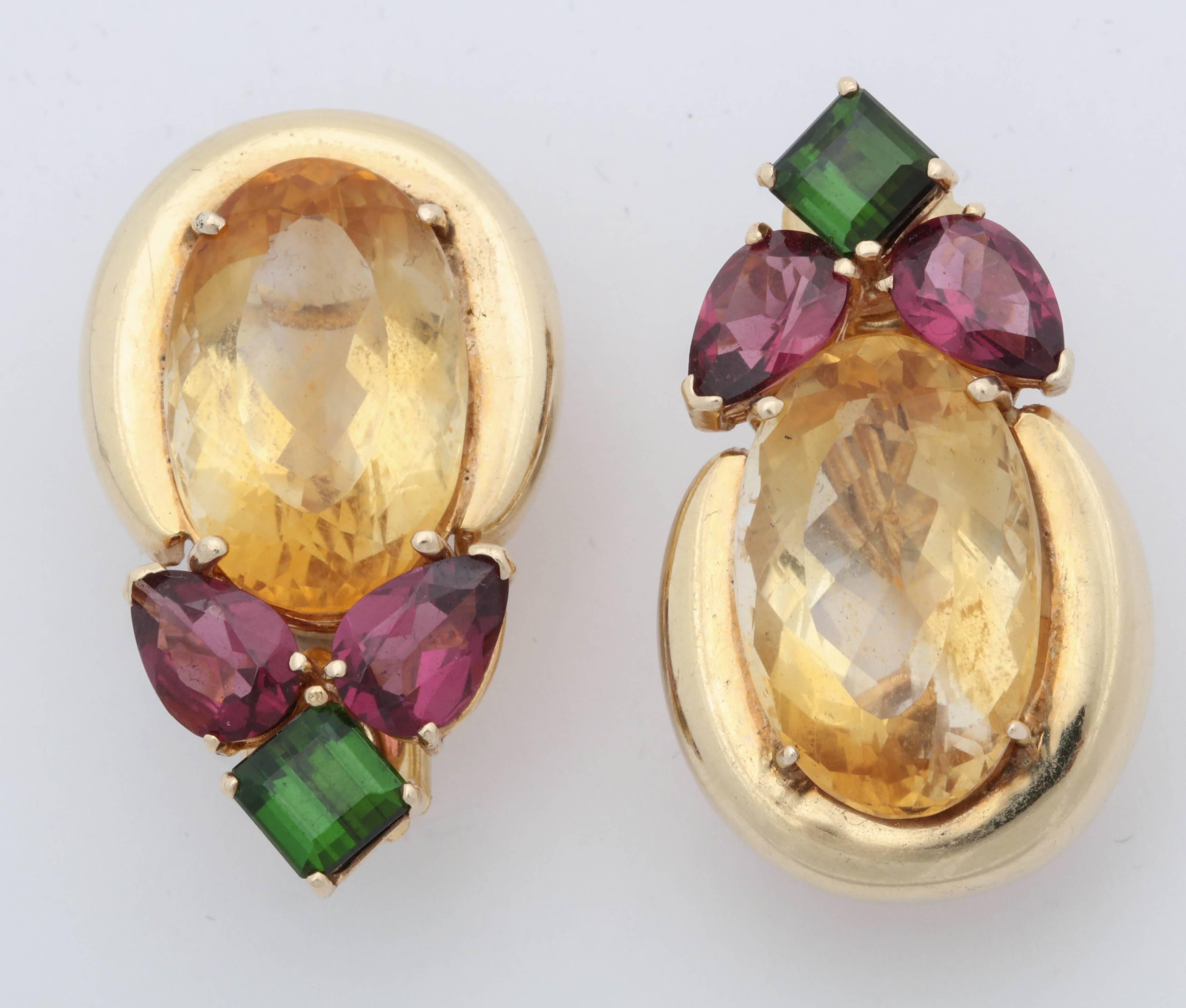 One Pair Of Ladies High Polish 14kt Yellow Gold Earrings Designed With Two Multifaceted Oval Shaped Citrines Measuring Approximately 19MM Each Stone. These Reversible Earrings Are Also Designed With Four Pear Shaped Pink Tourmalines Weighing