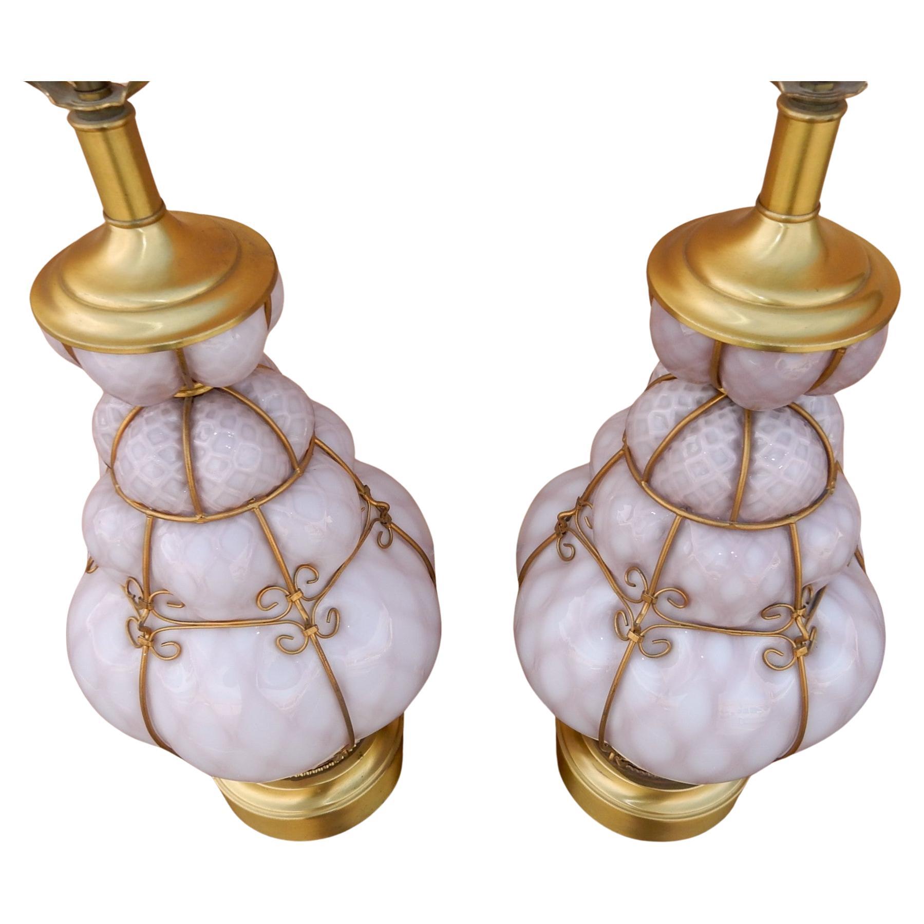 Large pair of gorgeous Italian hand blown cage art glass table lamp
attributed to Seguso Italy (not marked).
Violet colored glass with golden metal cage and hardware.
Both lamps are flawless.