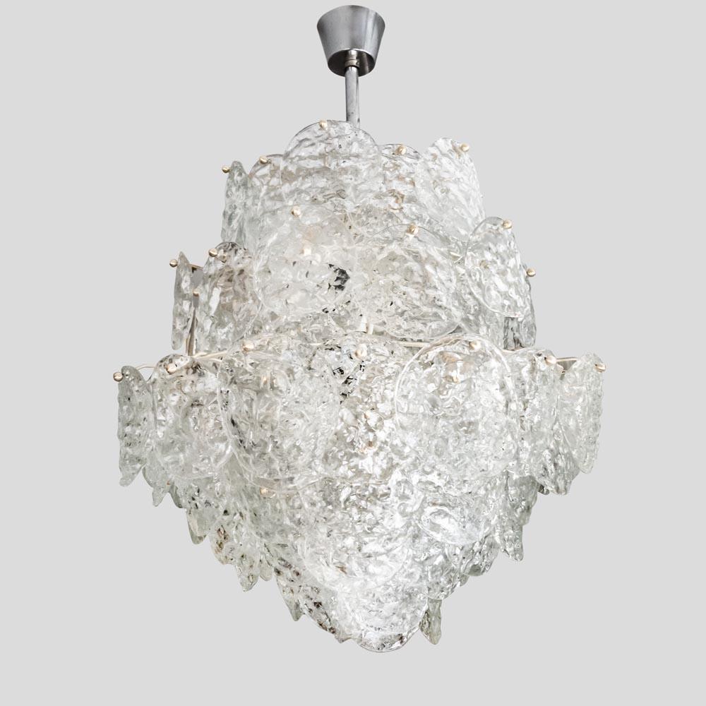 An Elegant 1950s ceiling light Italian design made in Murano island part of the Venetian archipelagos. This Blown clear glass and hand worked components ceiling light was produced by Av. Mazzega’s furnace. This chandelier is made up of clear hand