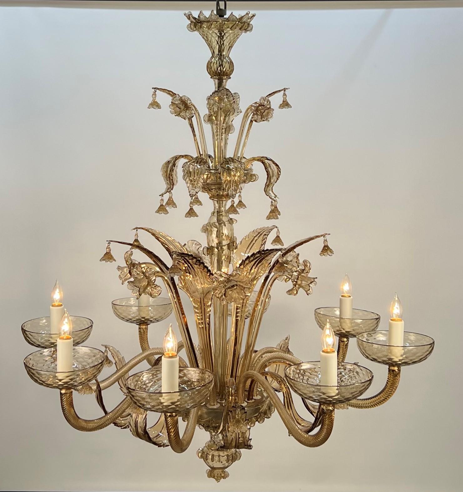 Presented is a beautiful large scale Murano chandelier in the Venetian taste. It embodies the core of classic Murano hand blowing and molding techniques. The amber glass is clear and rich in color without any gold flecks usually associated with