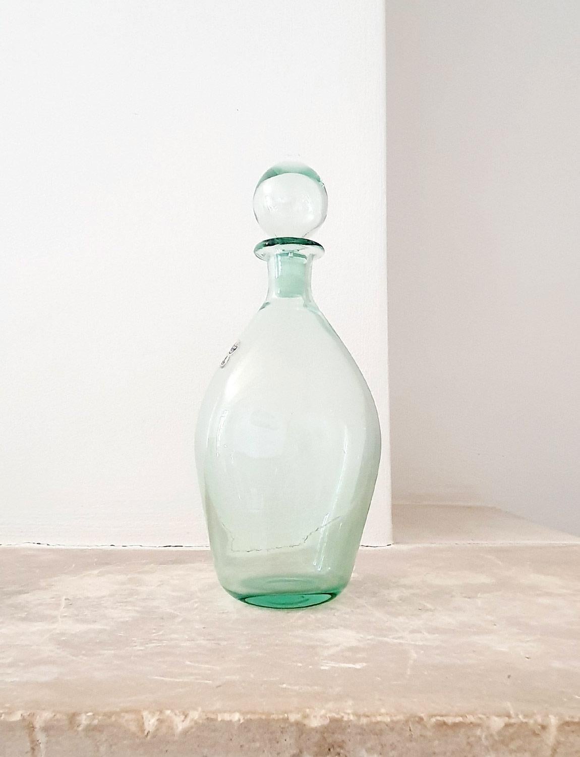 A beautifully light and clear pale green hand-blown bottle / decanter with hand-blown stopper by the Venetian furnace, Nason Moretti. The bottle still carries the Nason Moretti sticker. It is a beautiful piece in excellent condition.