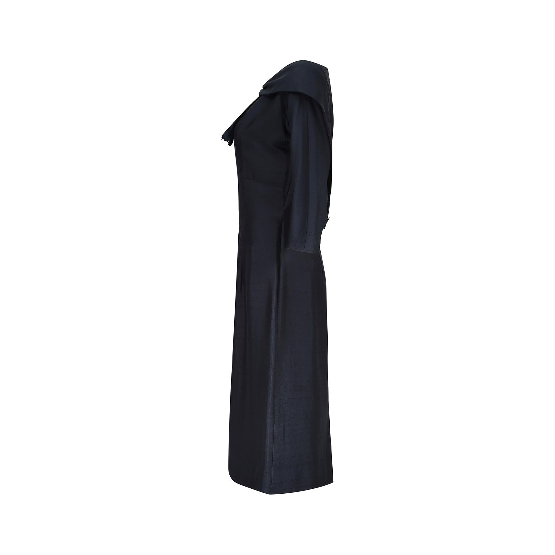 Original 1950s navy blue silk dress with a fabulously detailed shawl collar neckline that is designed to look like a capelet but is in fact integral to the dress. The faux tie detail at the front has these unusual 'frayed' ends designed to look like