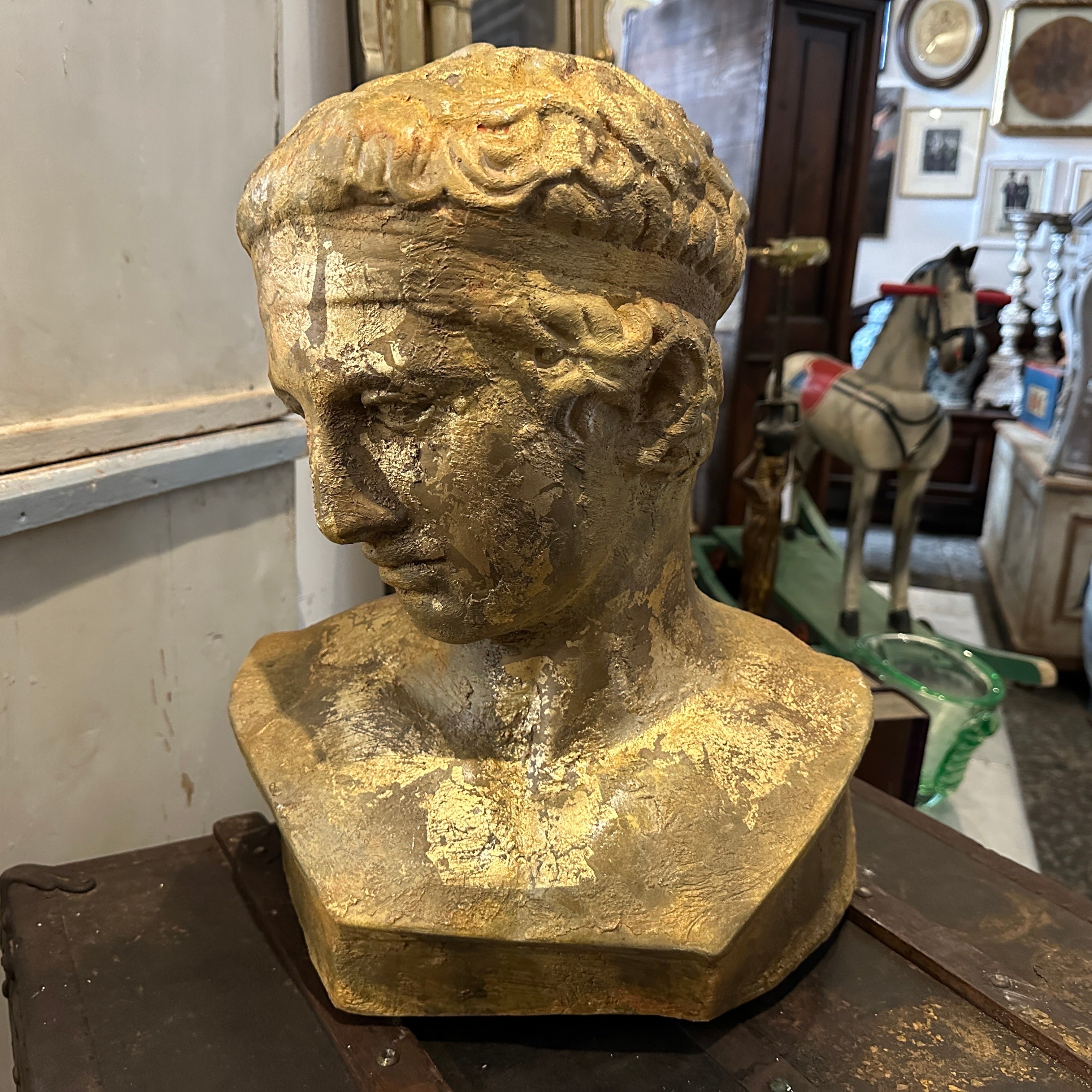 A gold patinated plaster bust of Diadumeno from a Gipsoteca in a sicilian academy of fine arts. They used to patinate the plasters in different ways, this one has been made with gold, amber and brown for this amazing result also given of the time,