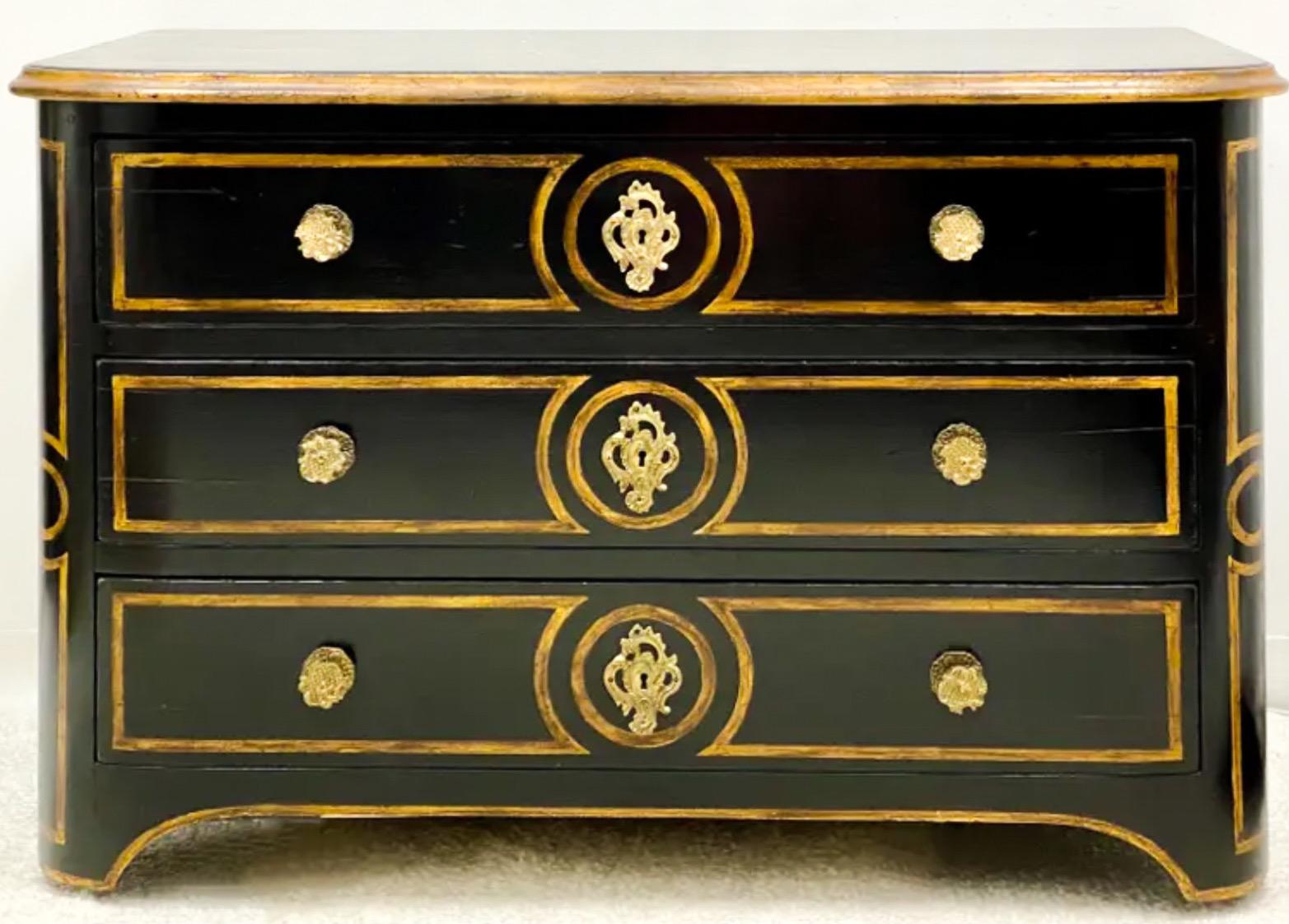 This amazing mid-century continental chest has a painted ebonized finish with gilt accents. The brass hardware is original. It is unmarked.