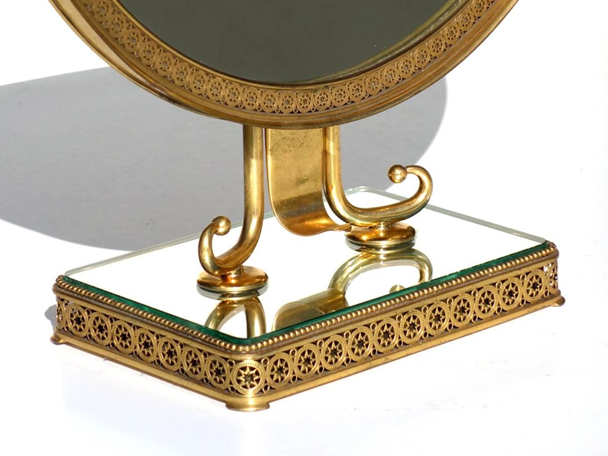 Neoclassical Vanity Mirror
Italy, 1950s.

Polished brass, crystal and wood
Great Manufacture.