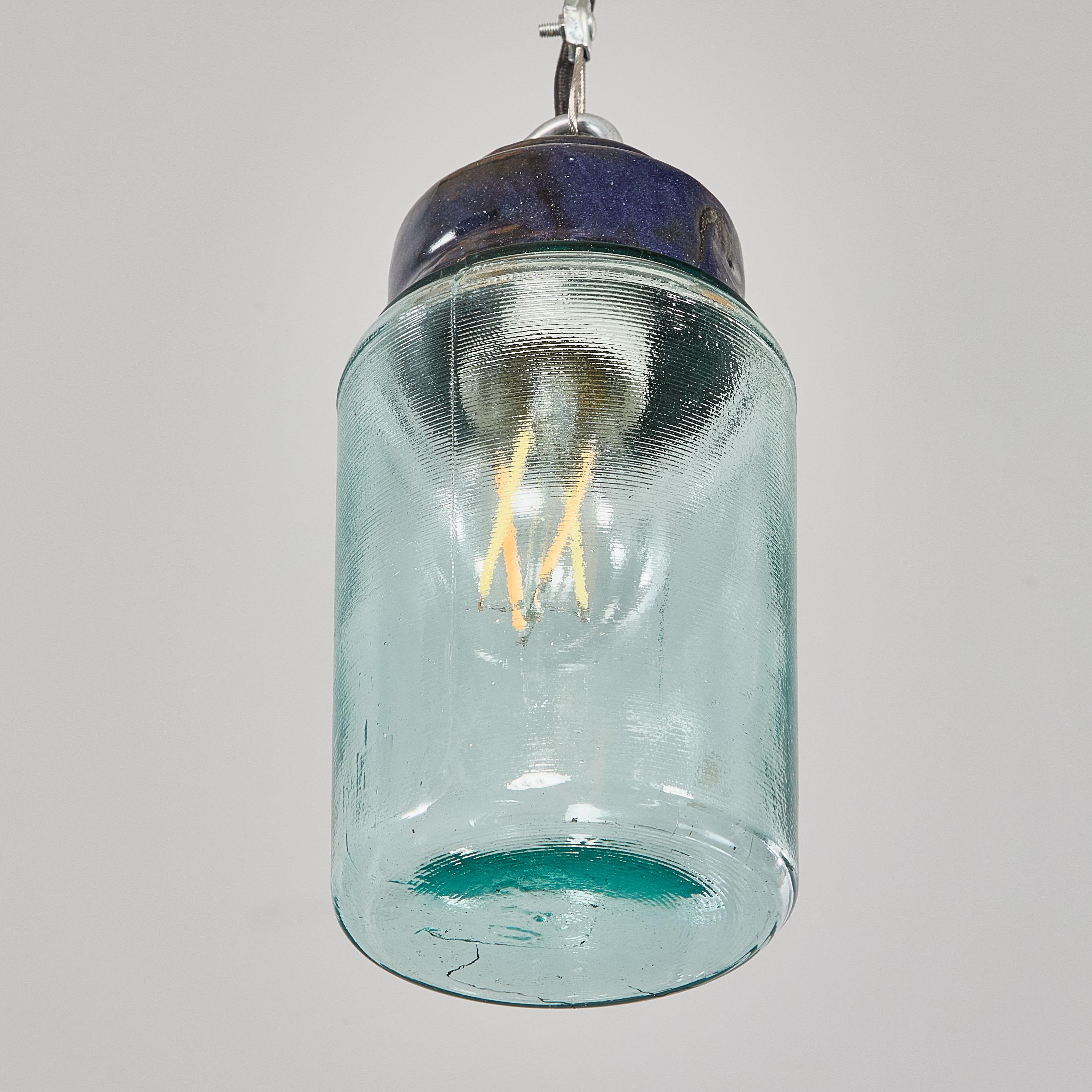 1950's New Old Stock Aqua Barrel Pendant Lamps - Good Quantity Available. 
The gallery tops are original Bakelite (self insulated) and simply screw into the aqua glass cylinders. Each lamp has been cleaned and restored. Listing is for one lamp. Each