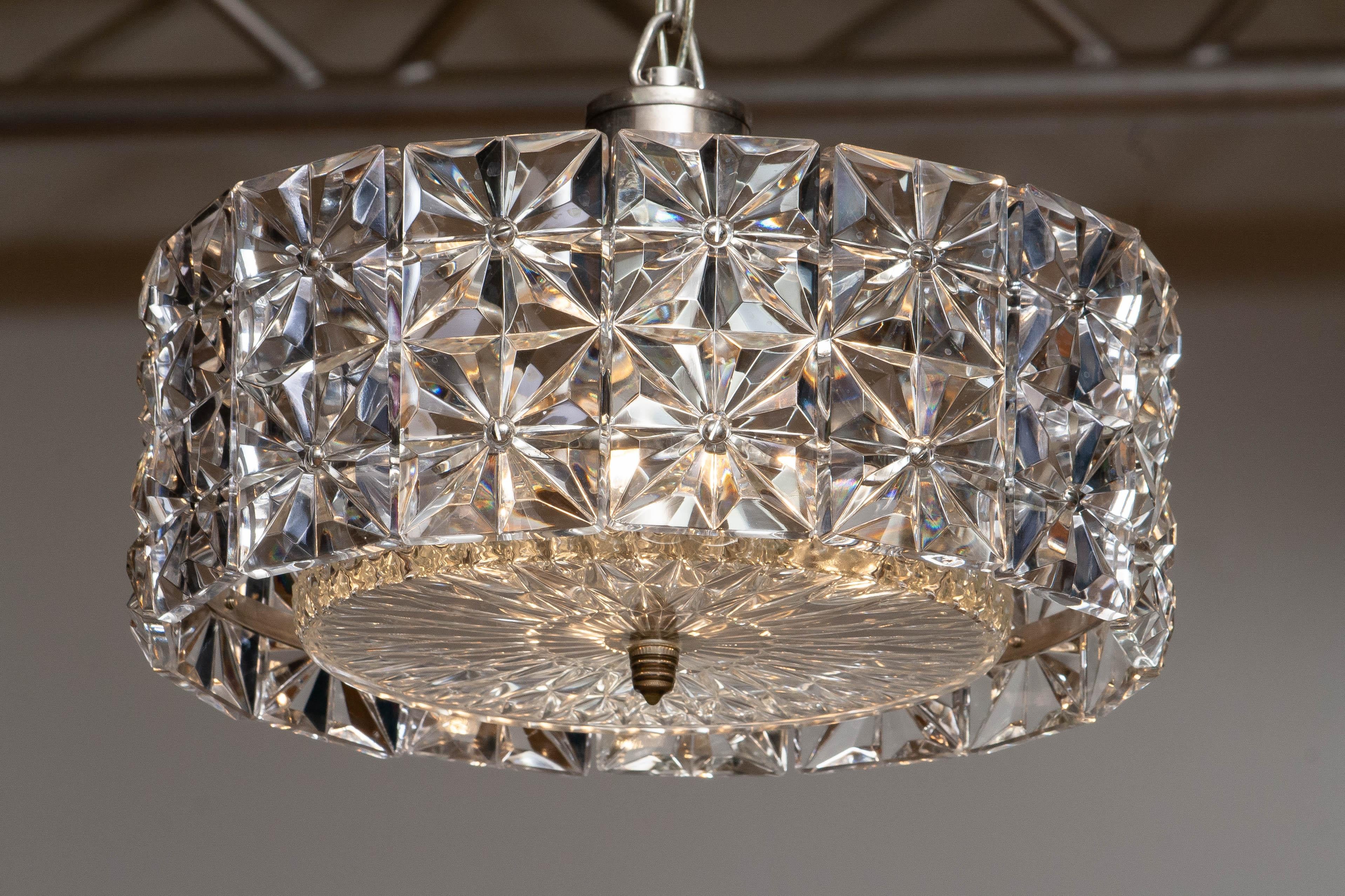 Beautiful and completely original two tier Hand-cut multi-faceted crystal segments chandelier by Kinkeldey Germany.
This chandelier consists three E14 / E17 screw bulbs and suits 230 and 110 volts.
Technically 100% and in a allover very good