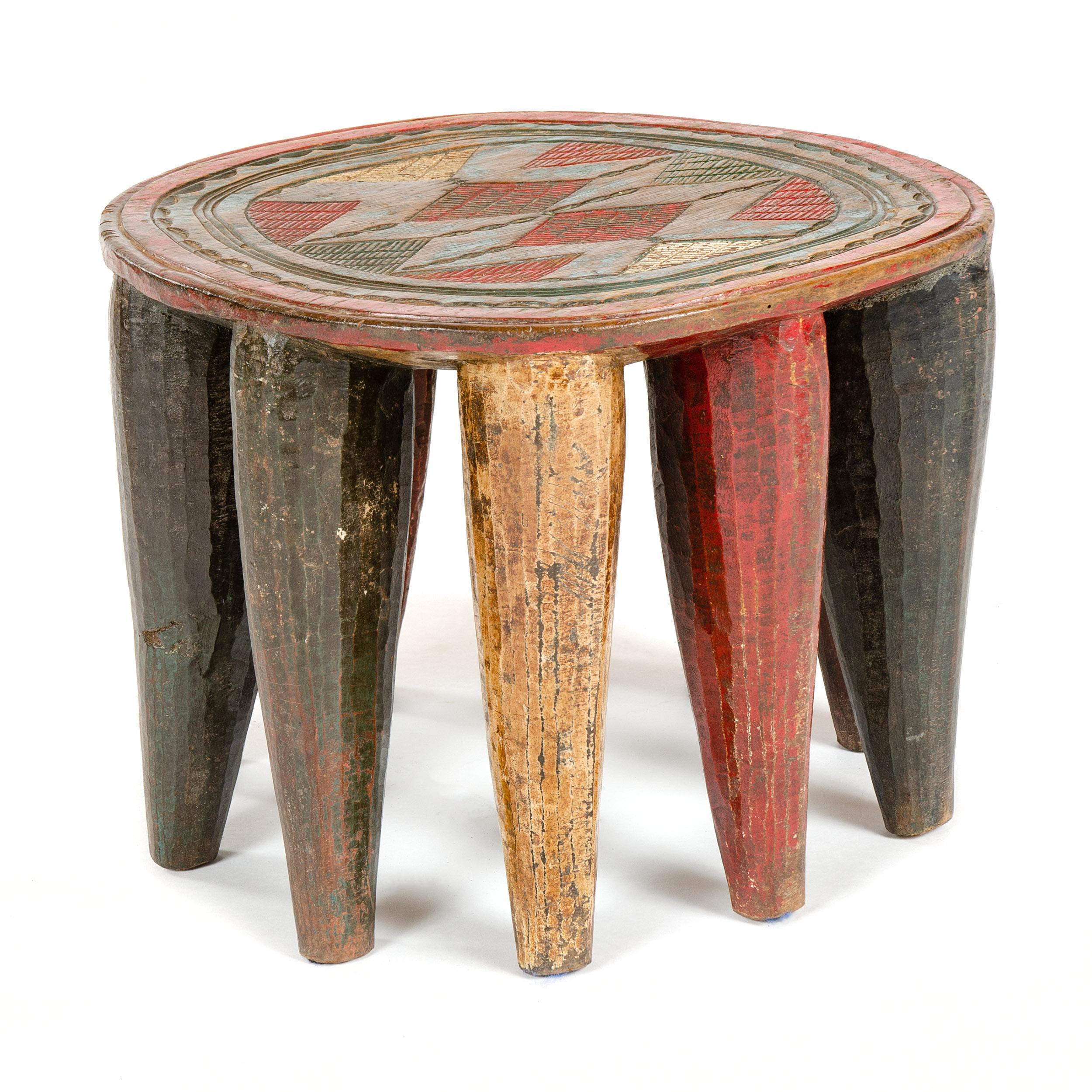 A vintage and intricately carved ten legged stool from the Nupe tribe of Nigeria.