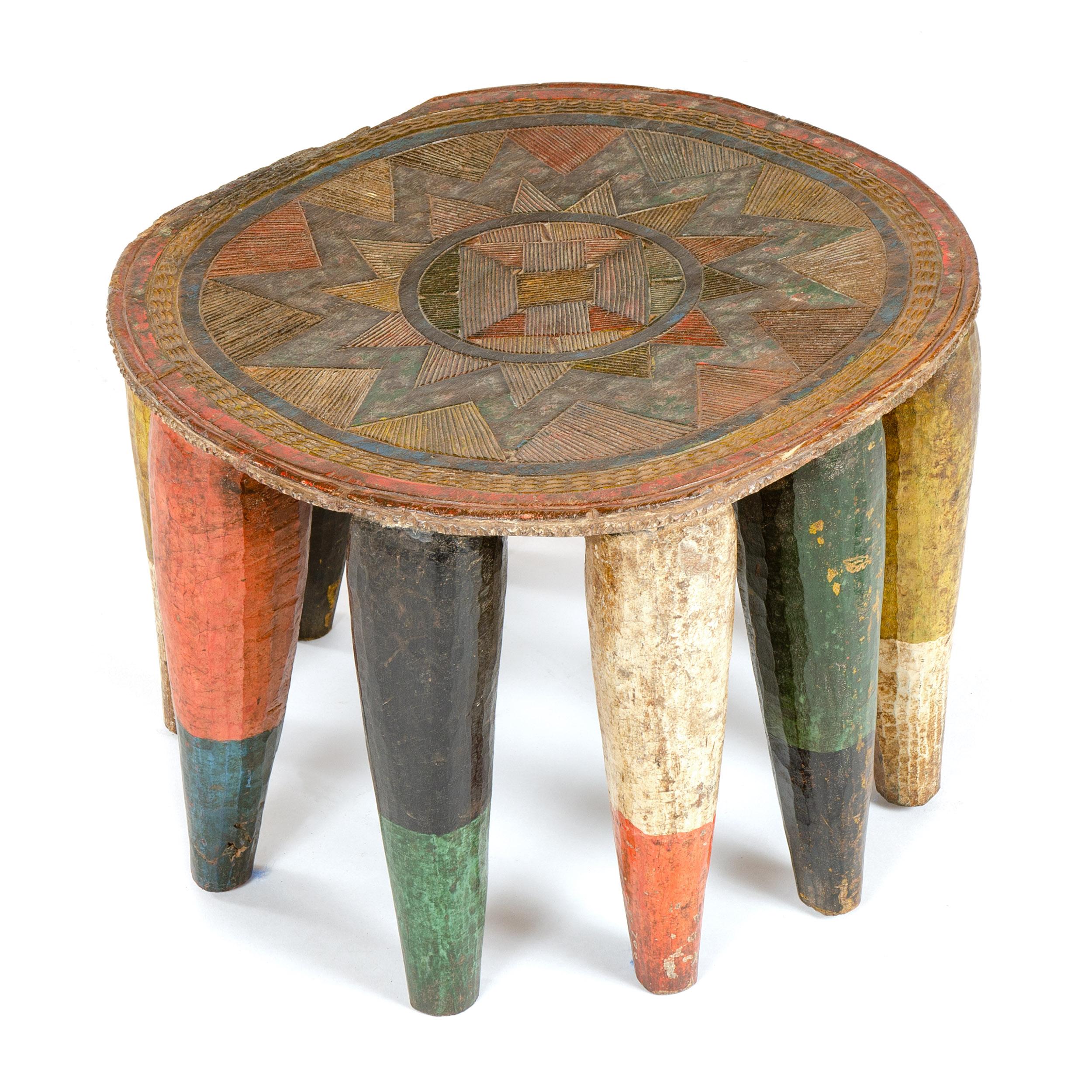 An intricately carved twelve legged stool from the Nupe tribe of Nigeria.