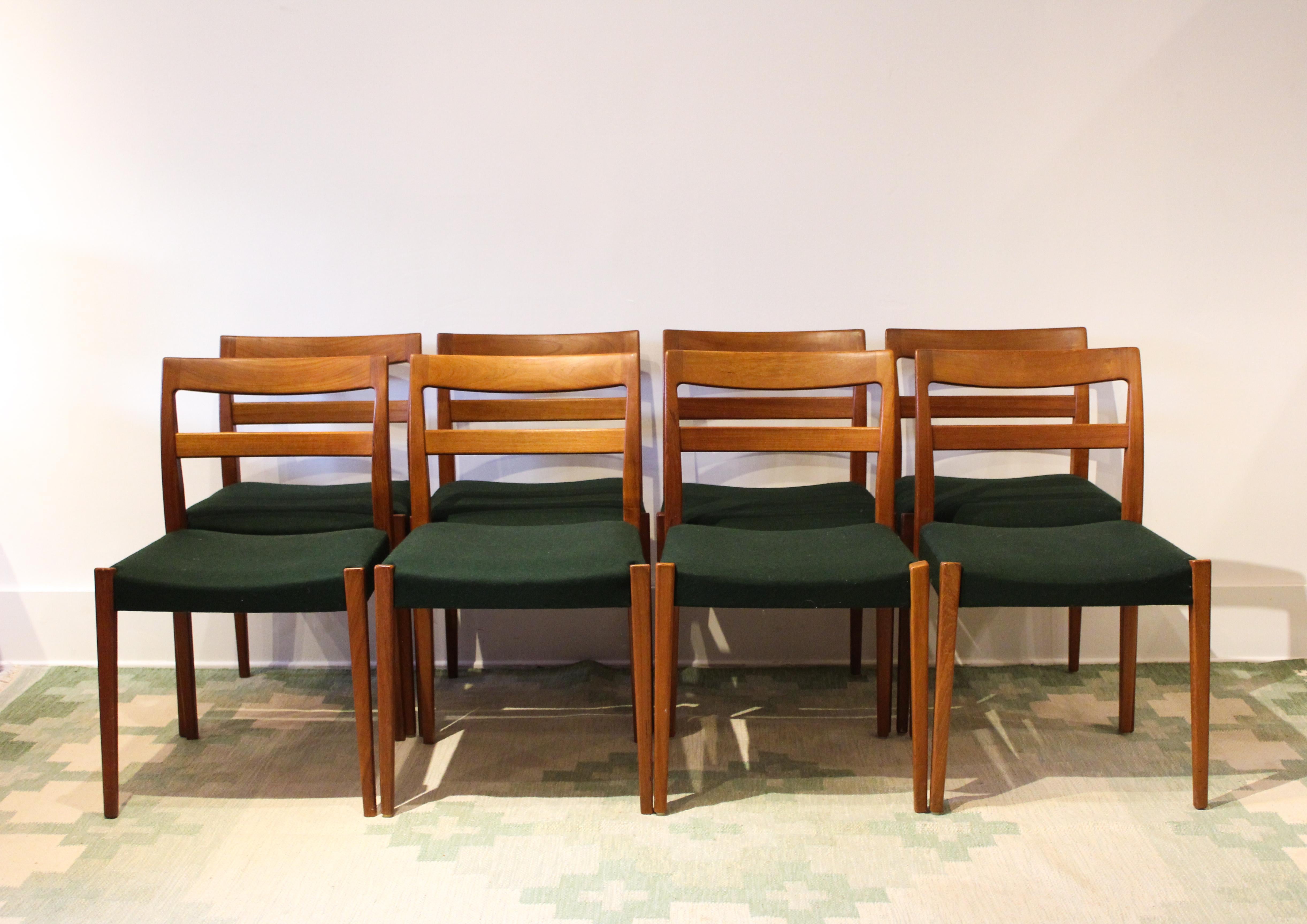 A nice set of eight midcentury teak dining chairs designed by Nils Jonsson for Troeds, Sweden. This model is called Garmi. All chairs have been upholstered in a green high quality wool fabric from Swedish manufacturer Klippan Yllefabrik. 

Very