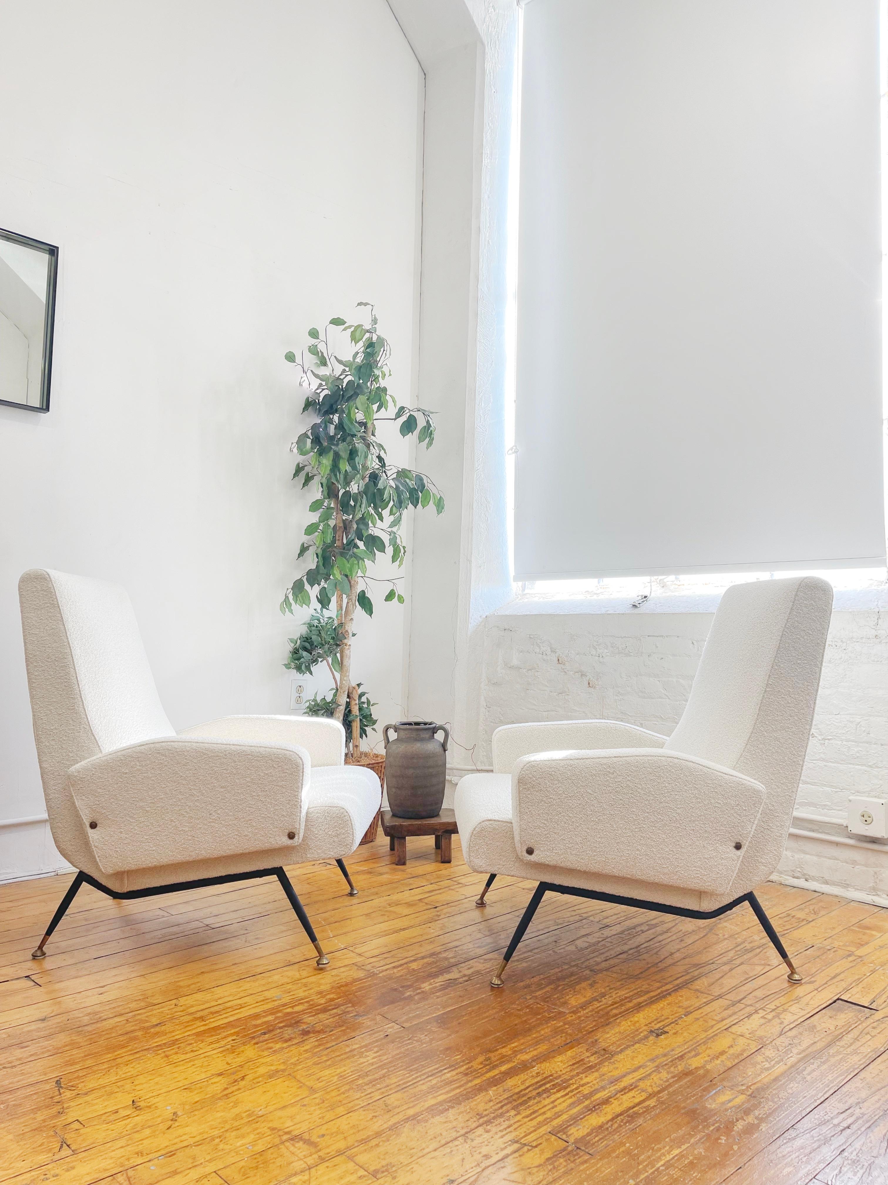 Transform your space with these exquisite Italian lounge chairs from the 1950s, designed by Nino Zoncada. Expertly restored and tastefully upholstered in a luxurious Italian white boucle, these vintage armchairs radiate timeless elegance and