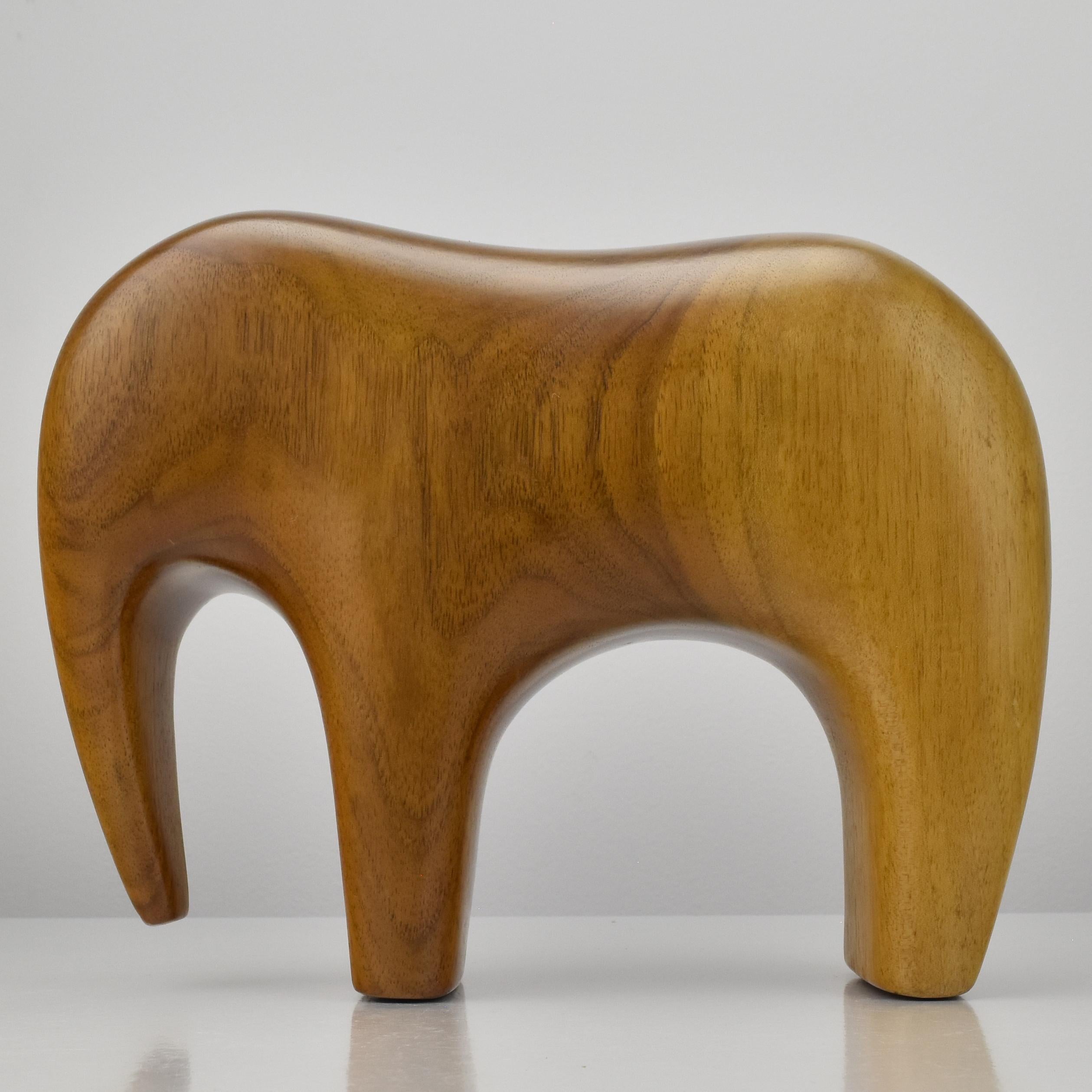 A  Minimalist hand-carved and polished teak wood elephant figurine in the style of Arne Tjomsland.

This sculpture is a perfect add-on for any Mid Century interior or a perfect gift for a collector of elephant figurines. 