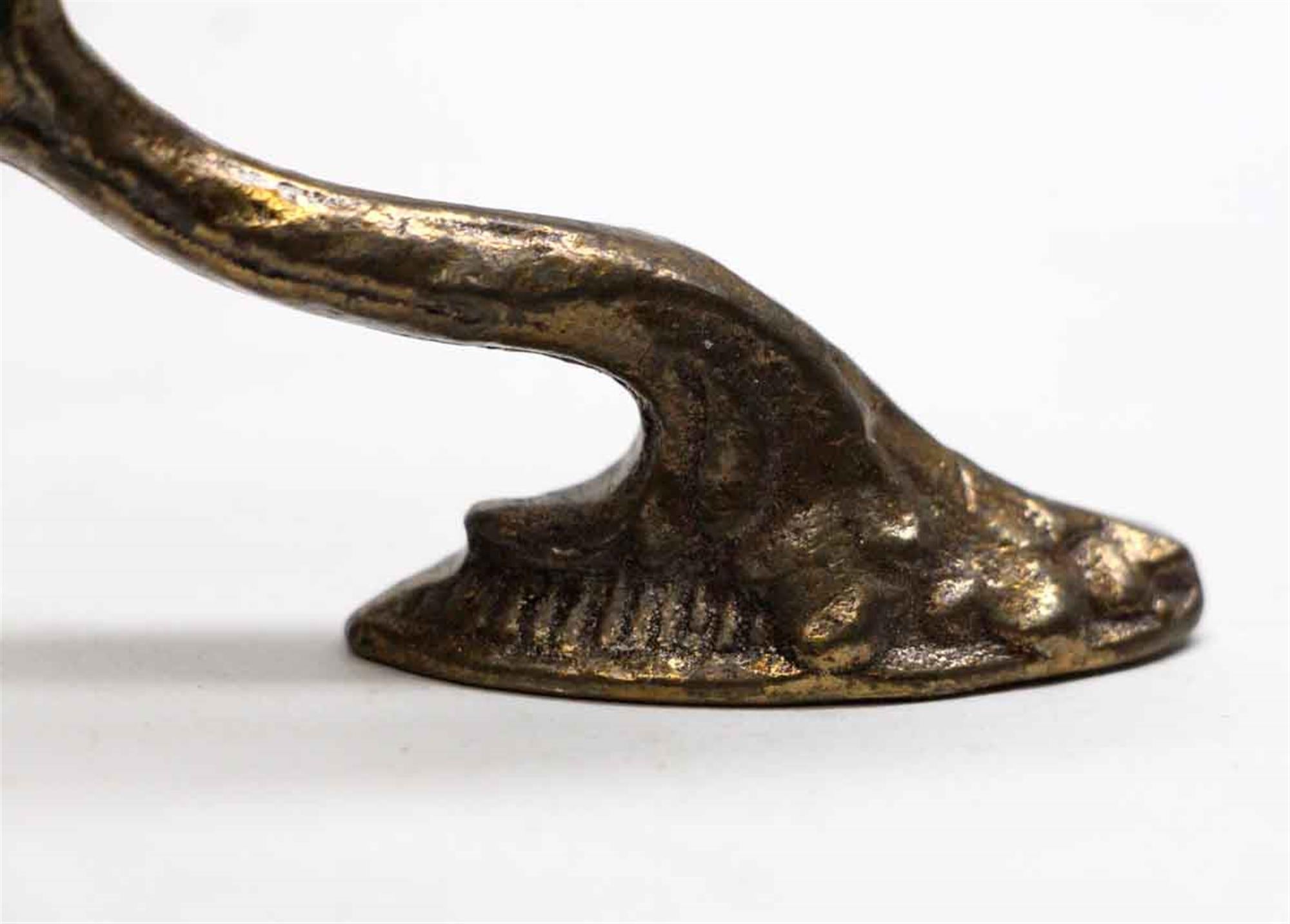 Mid 20th Century bronze curtain tie back hooks in the shape of a swan. From the famous Waldorf Astoria in New York City. Priced each. Waldorf Astoria authenticity card included with your purchase. This can be seen at our 302 Bowery location in