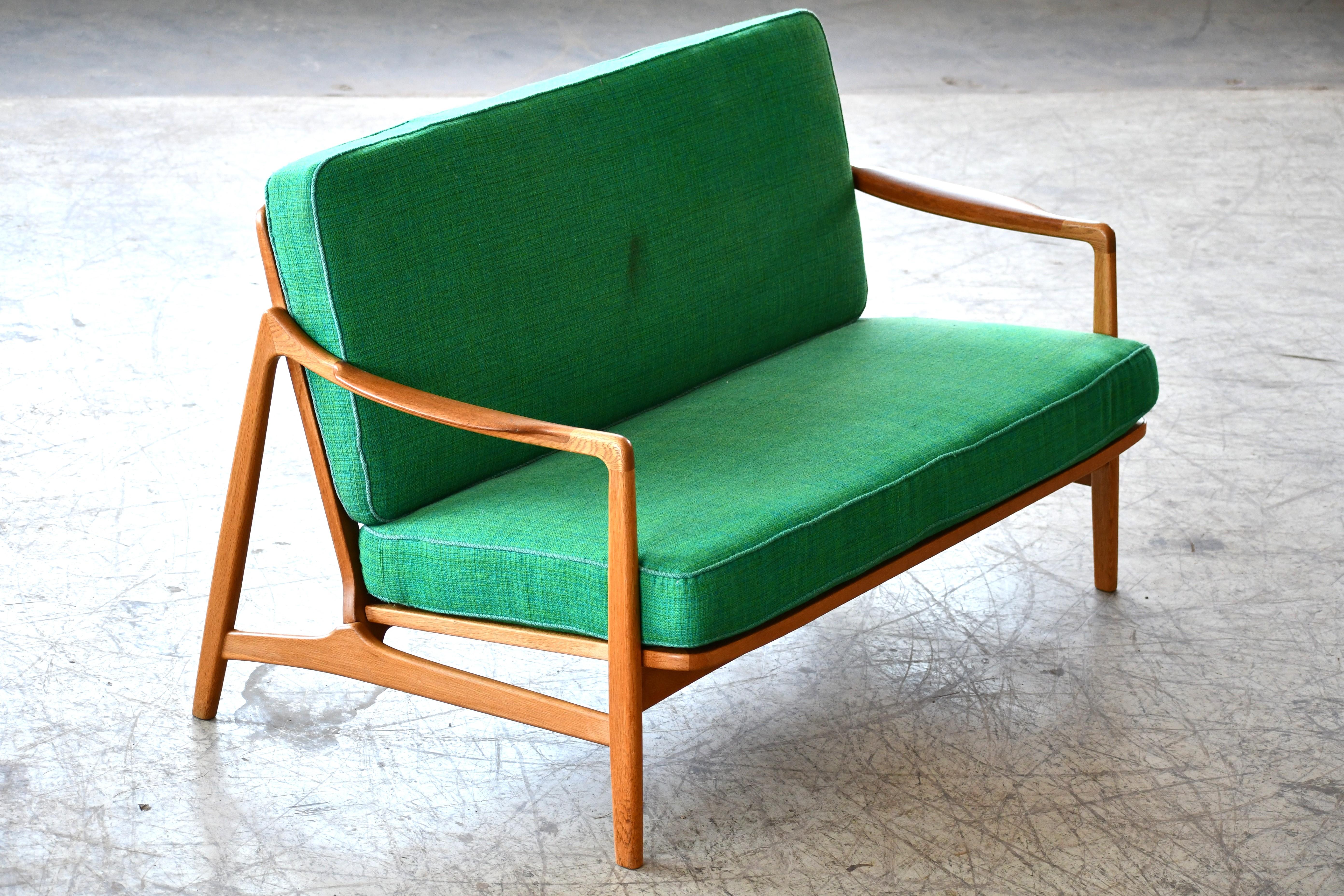 Rare Danish settee by Famed Danish Design Duo,Tove & Edward Kindt-Larsen. Produced by France & Daverkosen, Denmark early 1950s. Tove Kindt-Larsen (1906-1994) was one of Denmark’s most prominent designers from the 1930s to the 1960s. With a high