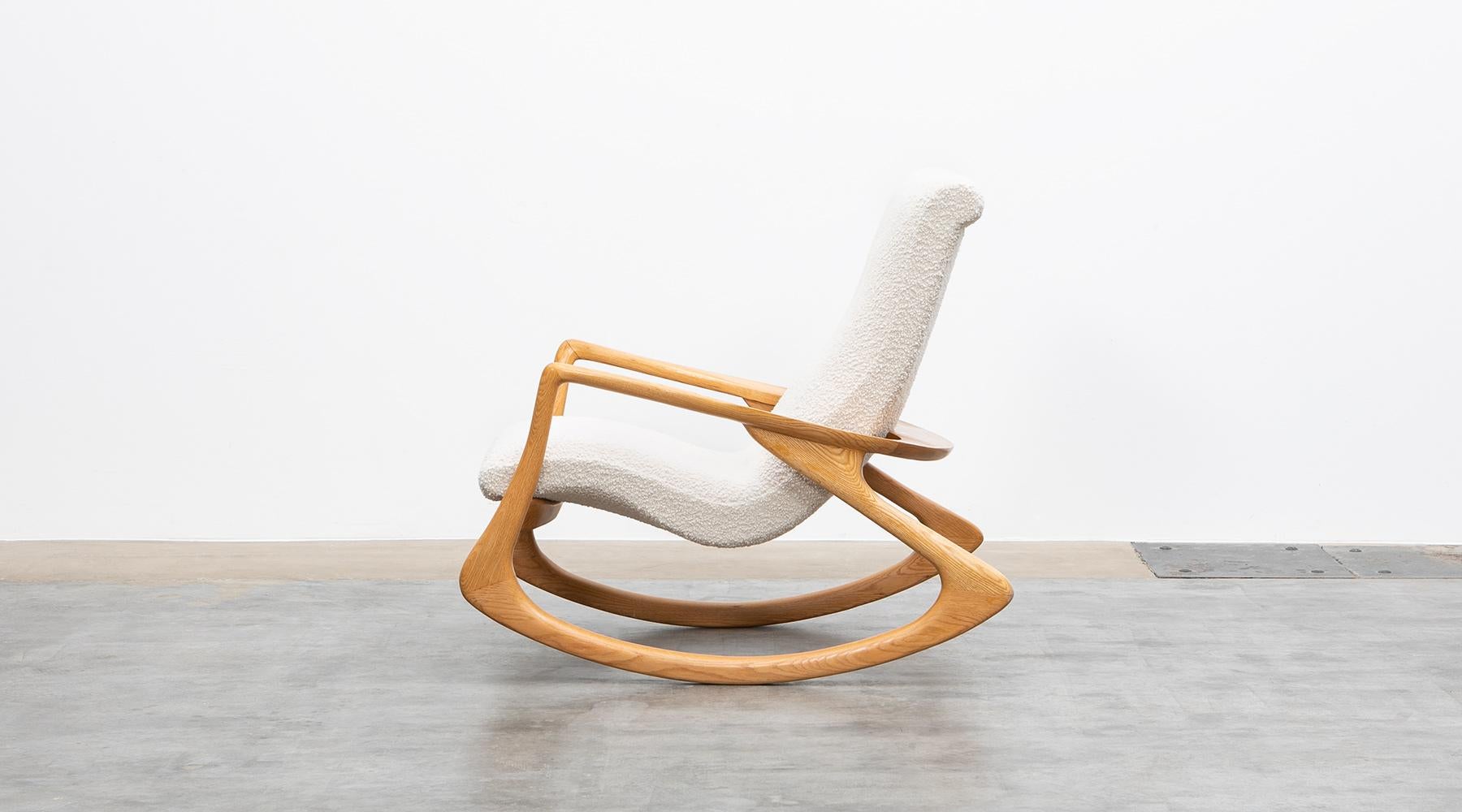 Rocking chair in oak, new upholstery, USA, 1955.

The wonderfully curved rocking chair is a very articulated composition of sweeping organic lines and shapes, where the armrests and legs merge almost inconspicuously. 

The US-American designer