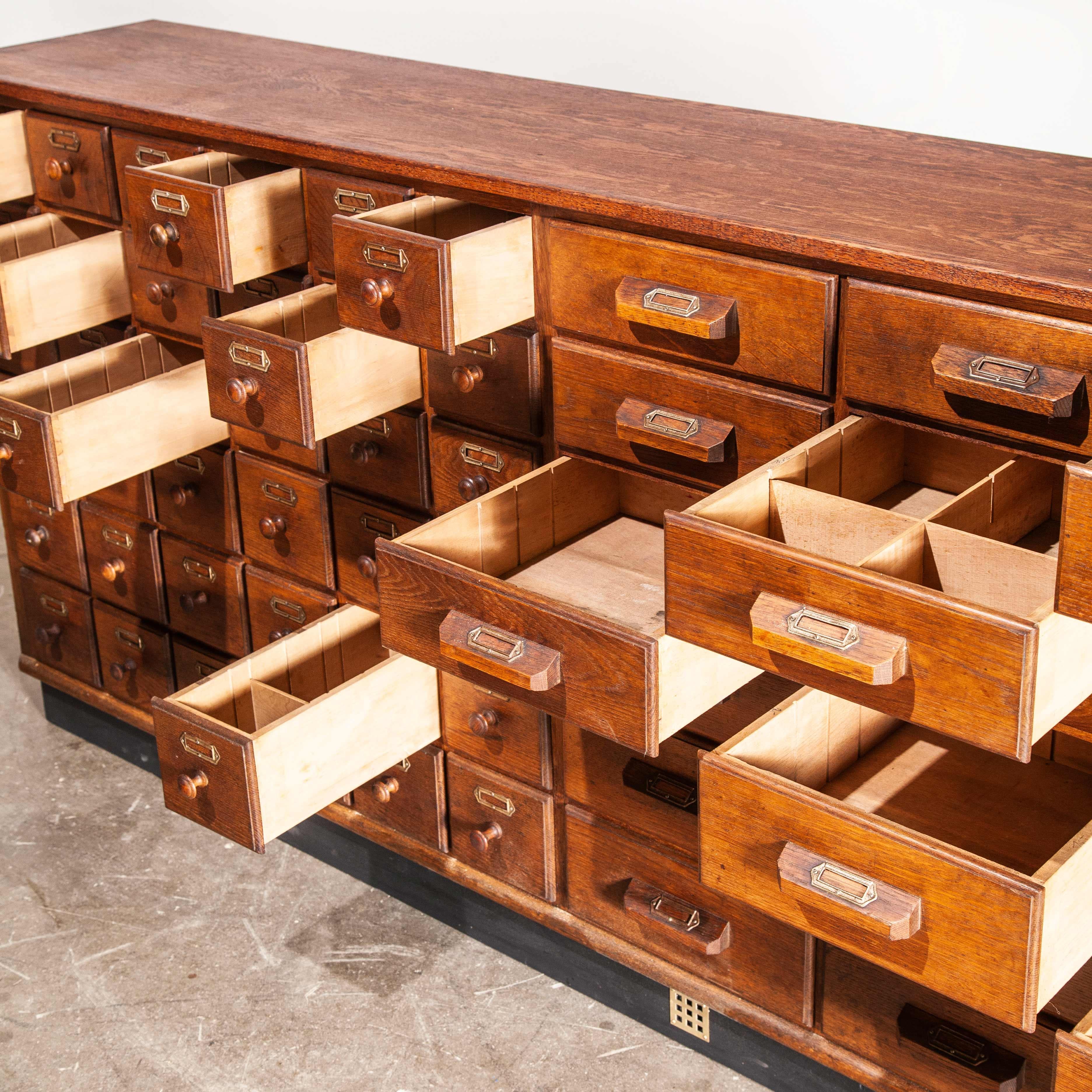 1950s oak apothecary multi drawer chest of drawers, fifty four drawers
1950s oak apothecary multi drawer chest of drawers, fifty four drawers. The chest of drawers has a paneled back, and boasts interchangeable dividers in some of the drawers. The