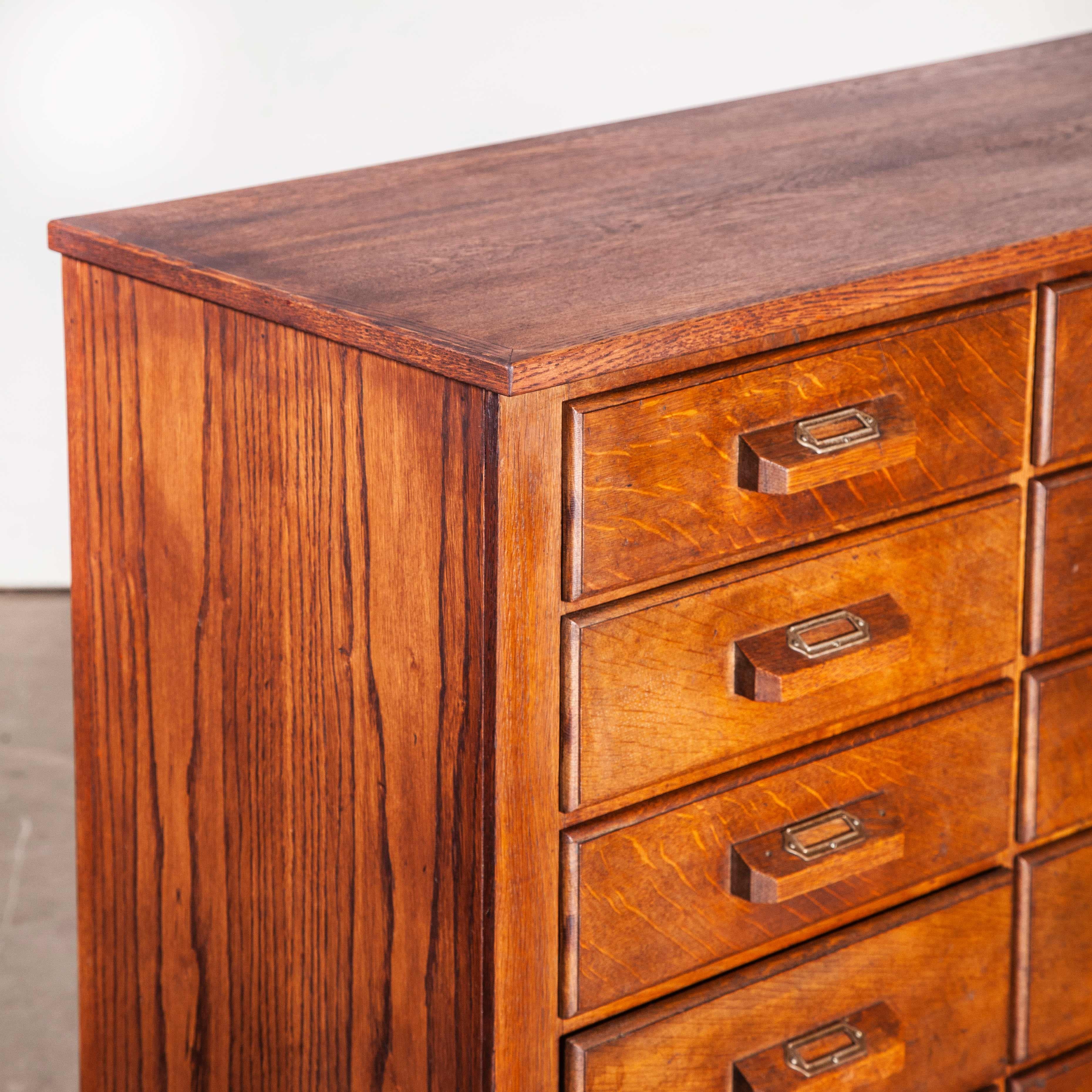 1950s oak apothecary multi drawer chest of drawers, twenty four drawers
1950s oak apothecary multi drawer chest of drawers, twenty four drawers. The chest of drawers has a paneled back, and boasts interchangeable dividers in some of the drawers.