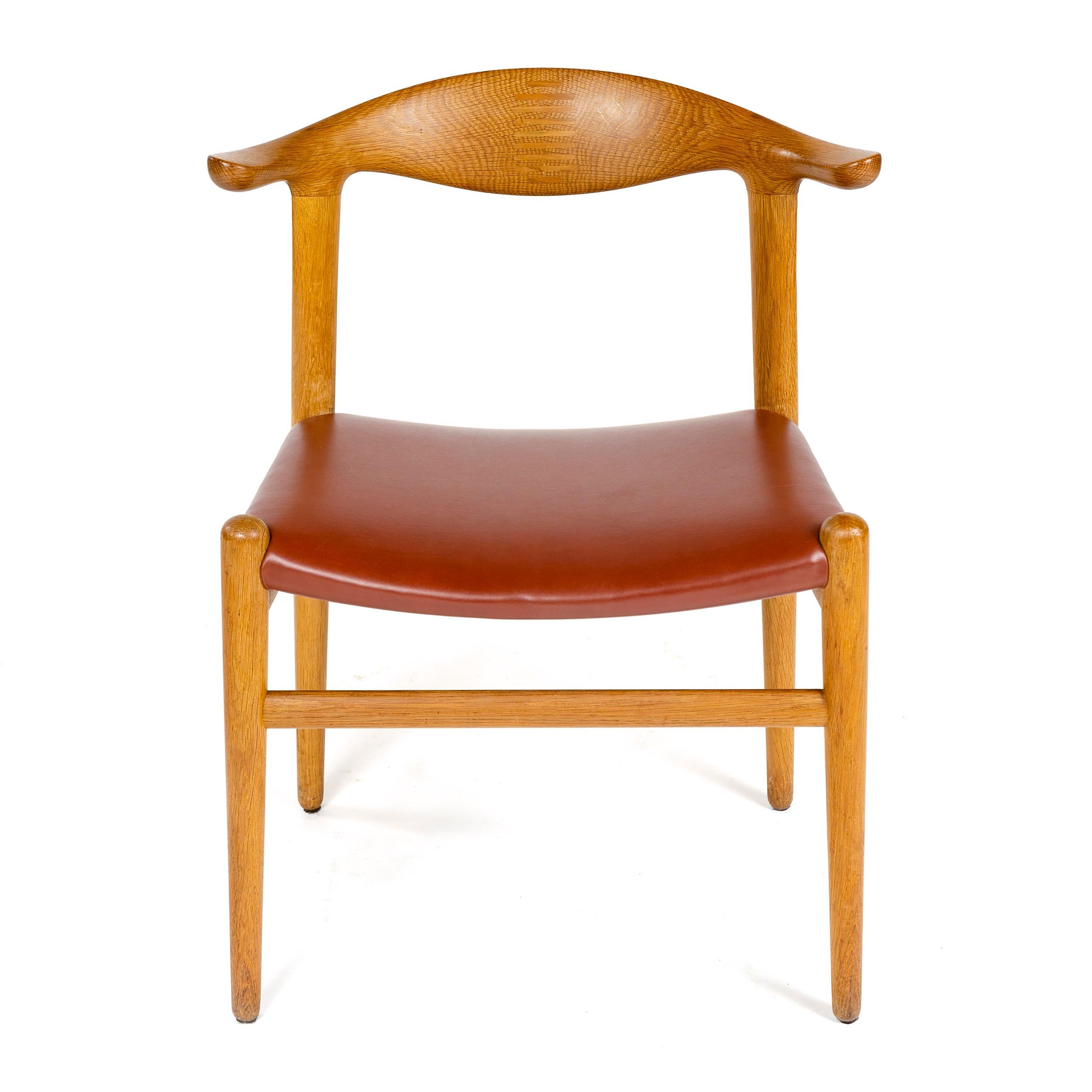 A rare oak 'cow horn' dining chair with a splined backrest and an upholstered leather seat.