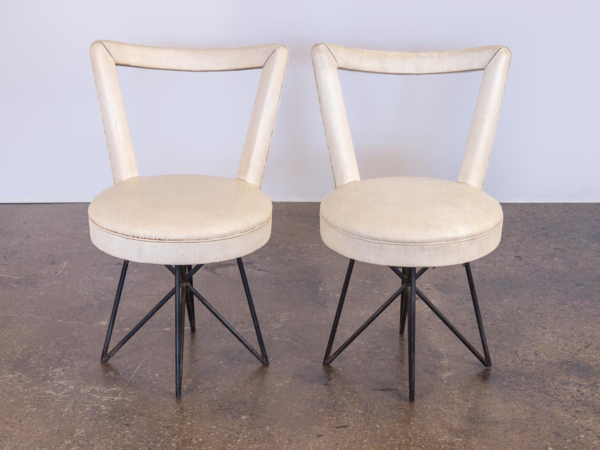 Pair of 1950s occasional side chairs in the manner of Mathieu Matégot. A fantastic set of dining chairs that would make excellent accent chairs, or work well outdoors for patios or gardens. These eye-catching vinyl chairs feature angular, open frame