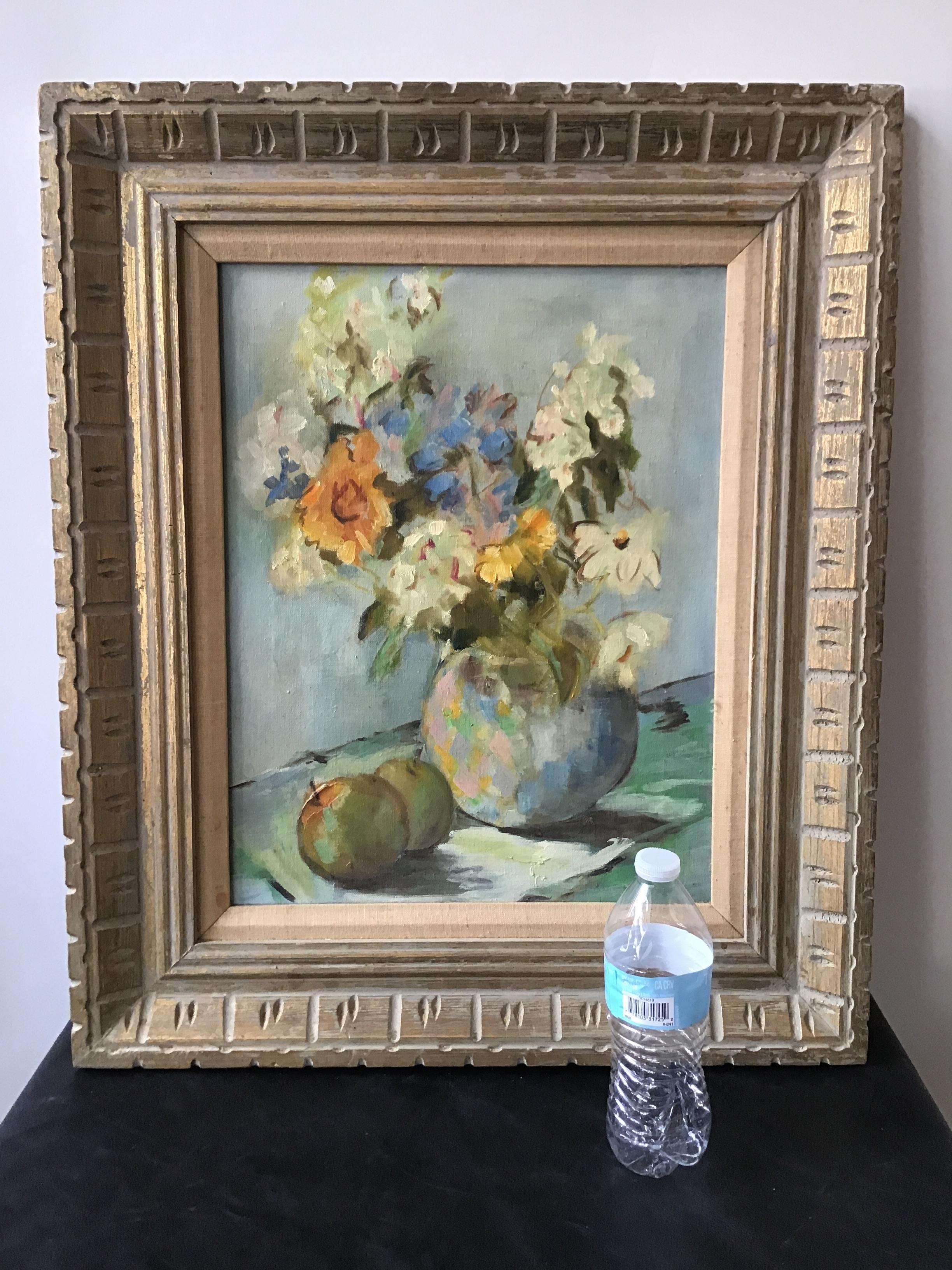 1950s oil on canvas of a floral arrangement. Signed on back. In a wood frame.