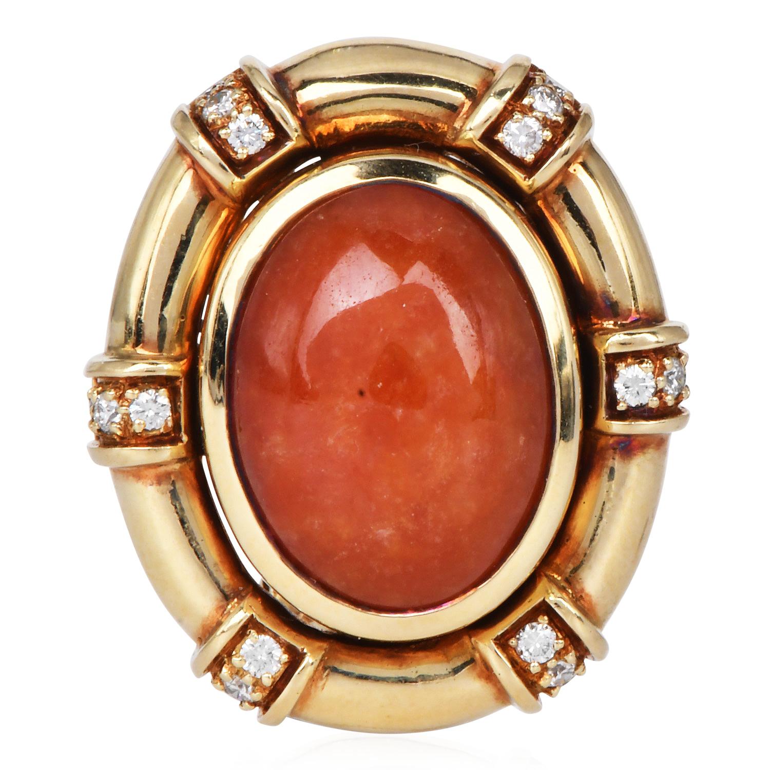 These vintage 1950s statement earrings feature vivid 21.65 carat orange jadeite cabochons bezel set in warm 14K yellow gold. Oval frame set with 36 round brilliant-cut diamonds, totaling approximately 0.56 carats, graded H-I color, SI clarity.