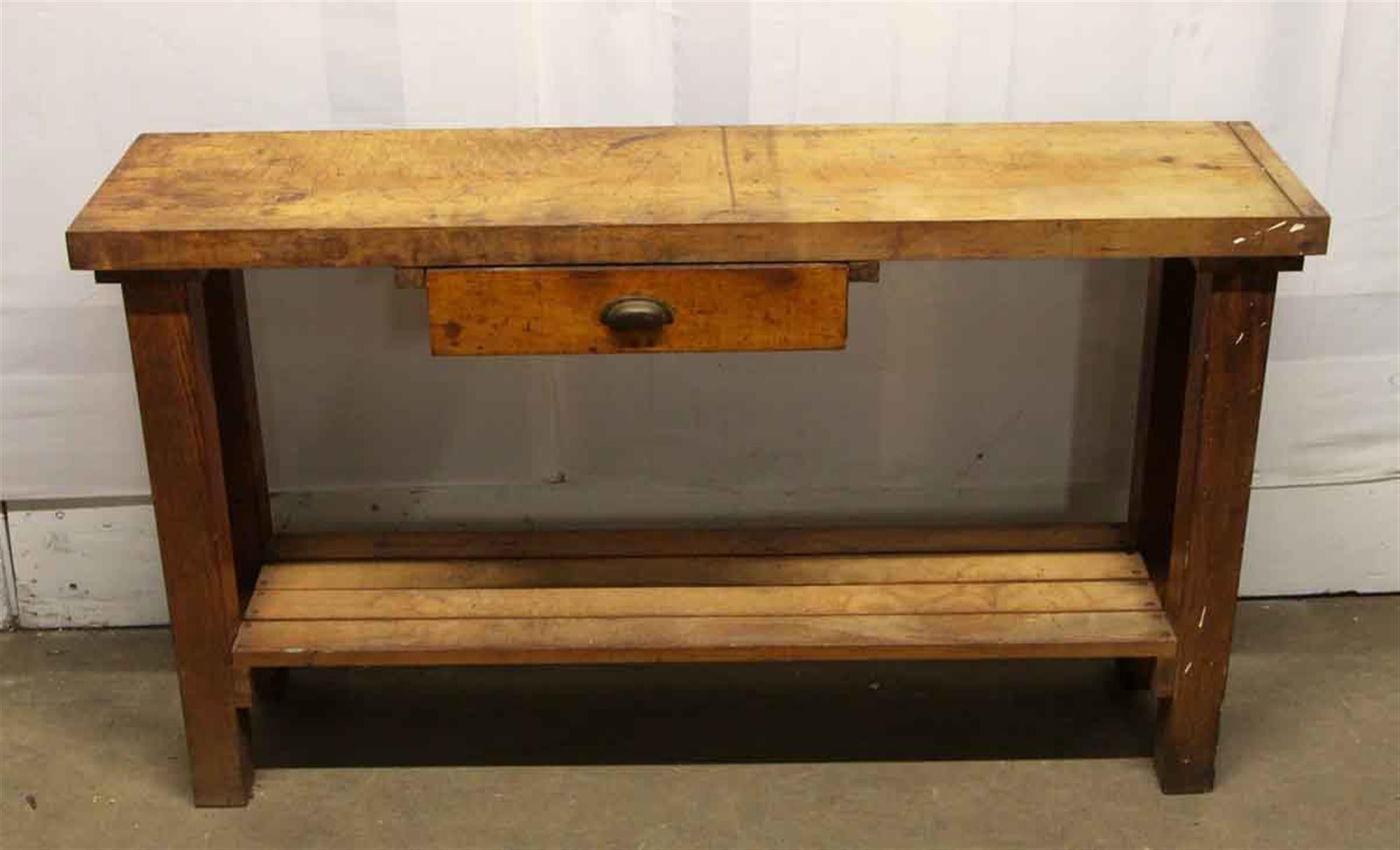 Work table with one single slightly off center drawer and two board shelf. Original distressing from the 1950s. This can be seen at our 302 Bowery location in Manhattan.