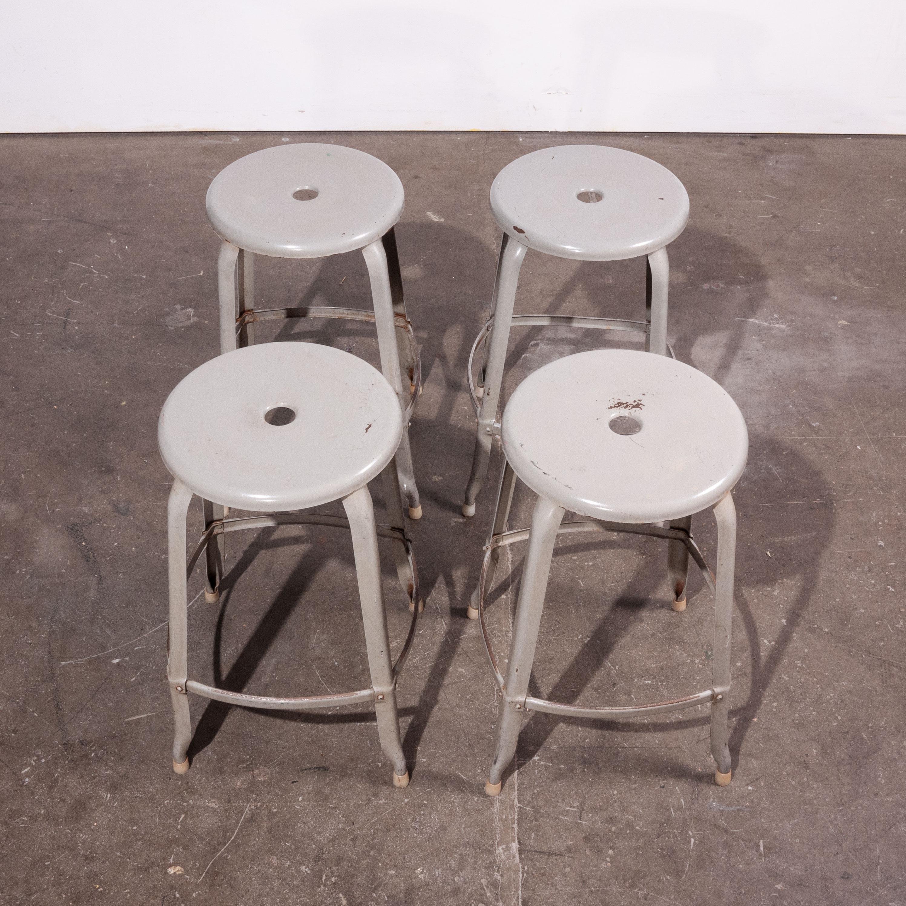 1950s vintage original industrial Nicholle stacking stools, set of four. One of our all time favourite products, exceptional in design with the minimal use of materials yet strong, well proportioned and so beautiful. Sourced from a laboratory in