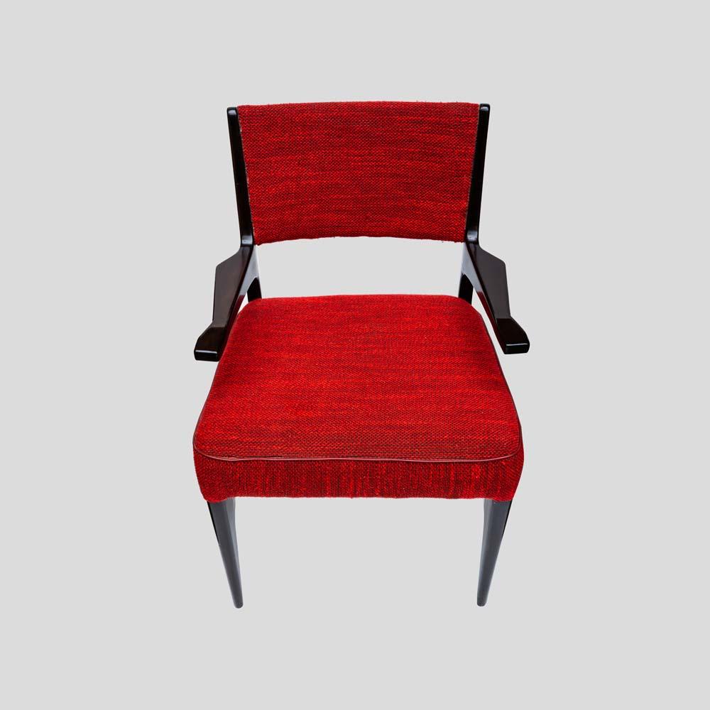 A vintage Italian design armchair, dark chocolate brown wood structure with tapered legs and harms . Original red fabric  upholstery design by Cassina ca. 1950s