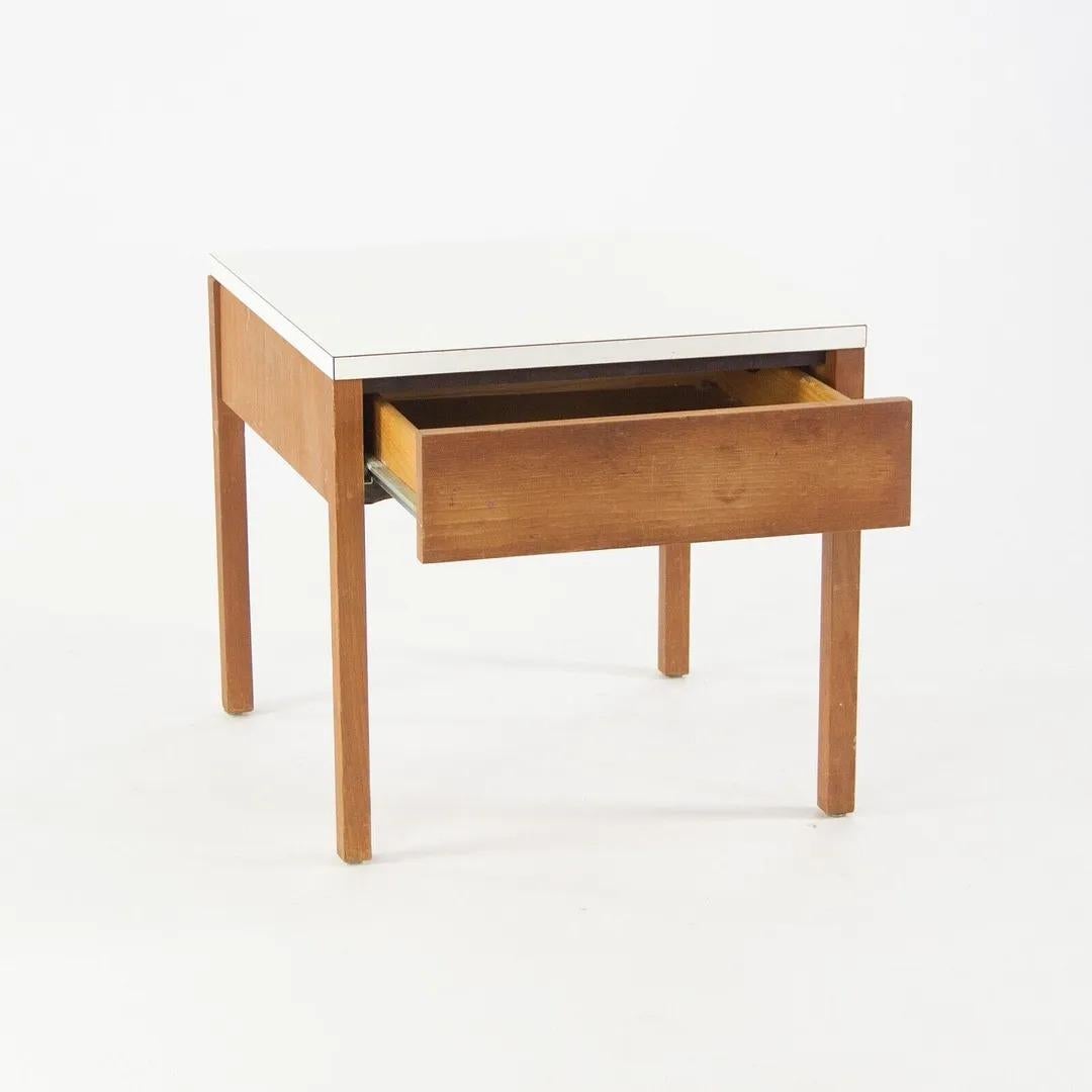 Listed for sale is a vintage 1950's Florence Knoll walnut and white laminate bedside table, produced by Knoll Associates. The table is in very nice condition with beautiful patina. It is a totally original example, nicely preserved. It came from an