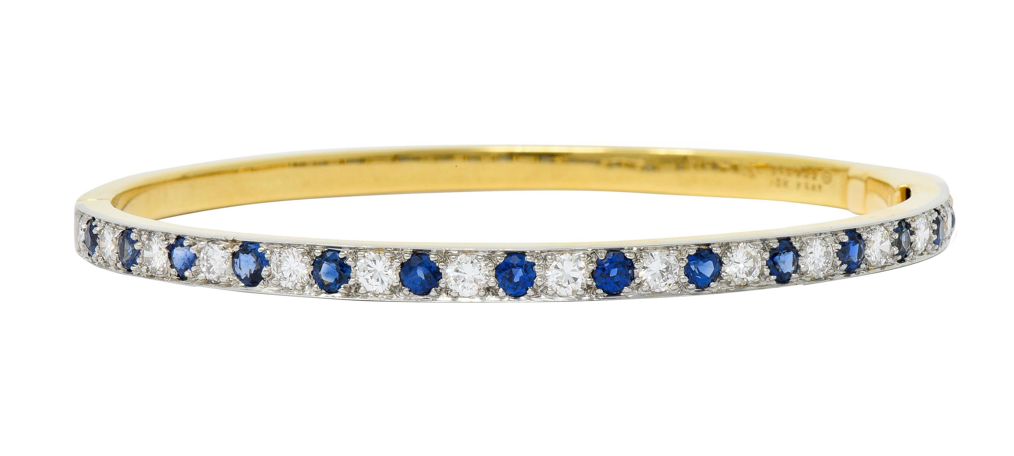 18 karat gold hinged bangle bracelet featuring a platinum top

Bead set with round brilliant cut diamonds and round cut sapphire, alternating

Total diamond weight is approximately 1.50 carats with G/H color and VS clarity

Sapphires are a very-well