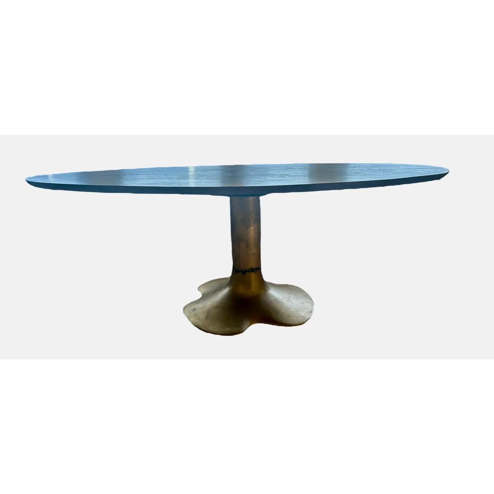 A rare and beautiful mid century coffee table by Slovenian industrial designer and artist Oskar Kogoj. The table has a sculptural bronze pedestal and oblong rosewood table top. Some chips on base and glass ring on table top.
