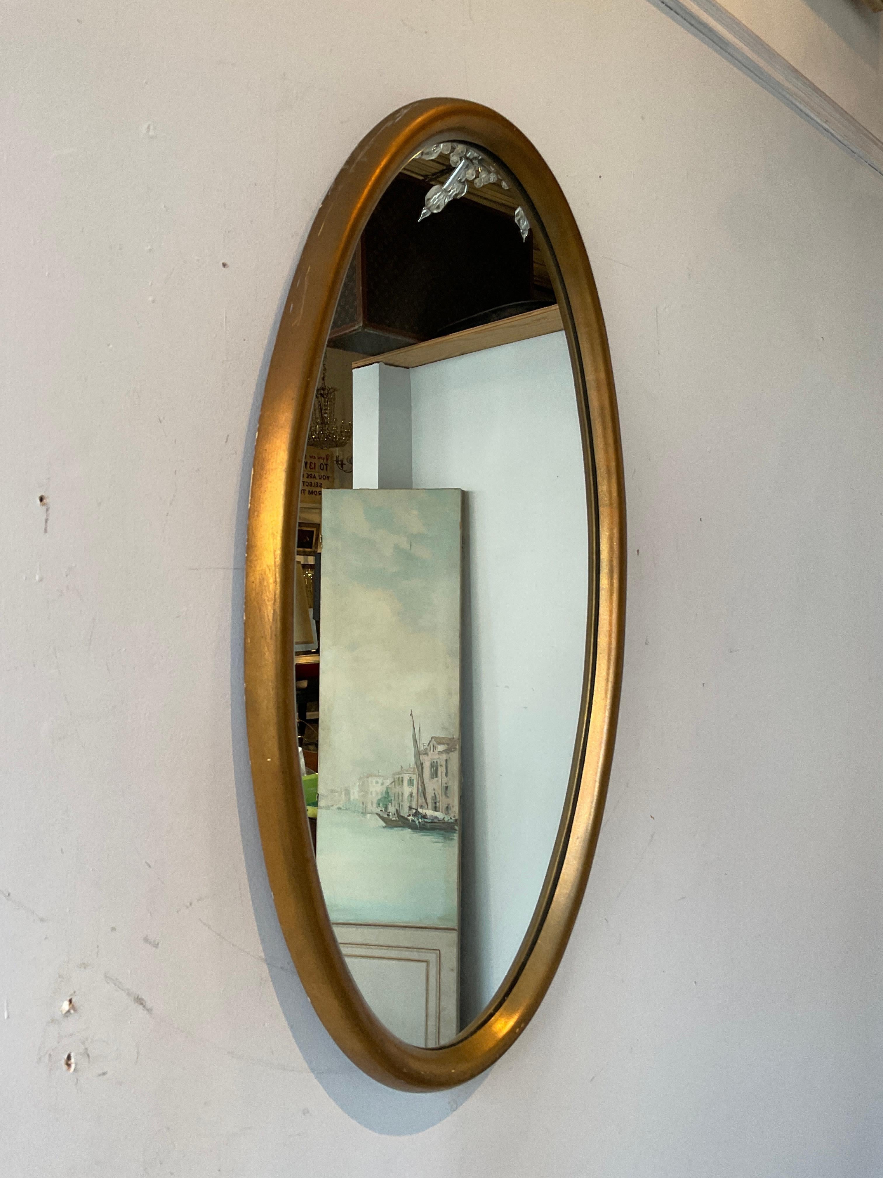 1950s gold oval gilt wood mirror.