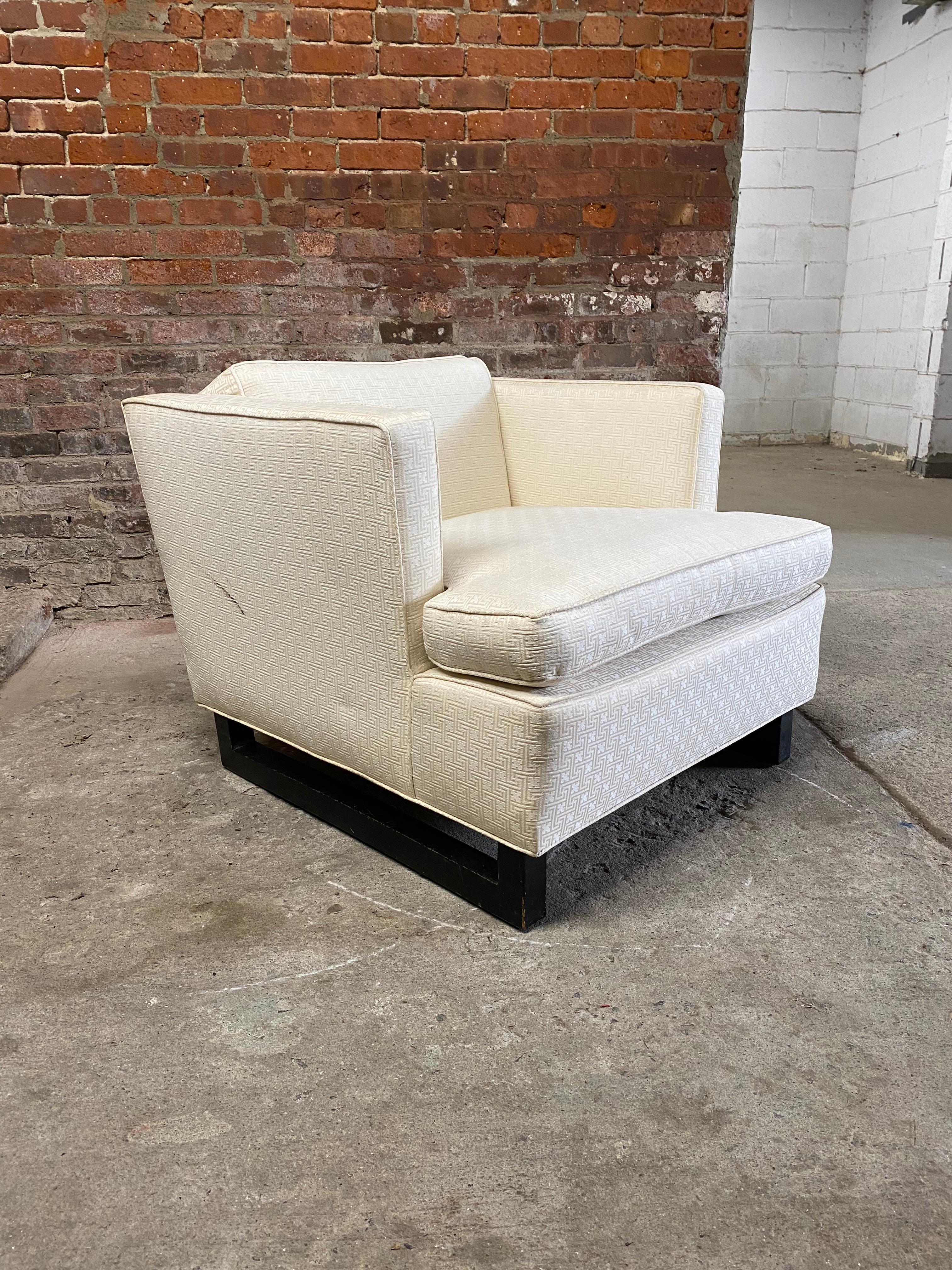 Wonderful transitional deep seat lounge chair with sleigh base. White Versace style upholstery with ebonized wood sleigh base. The lines and construction of this chair embody the elegance of the Art Deco and Hollywood Regency experience with the