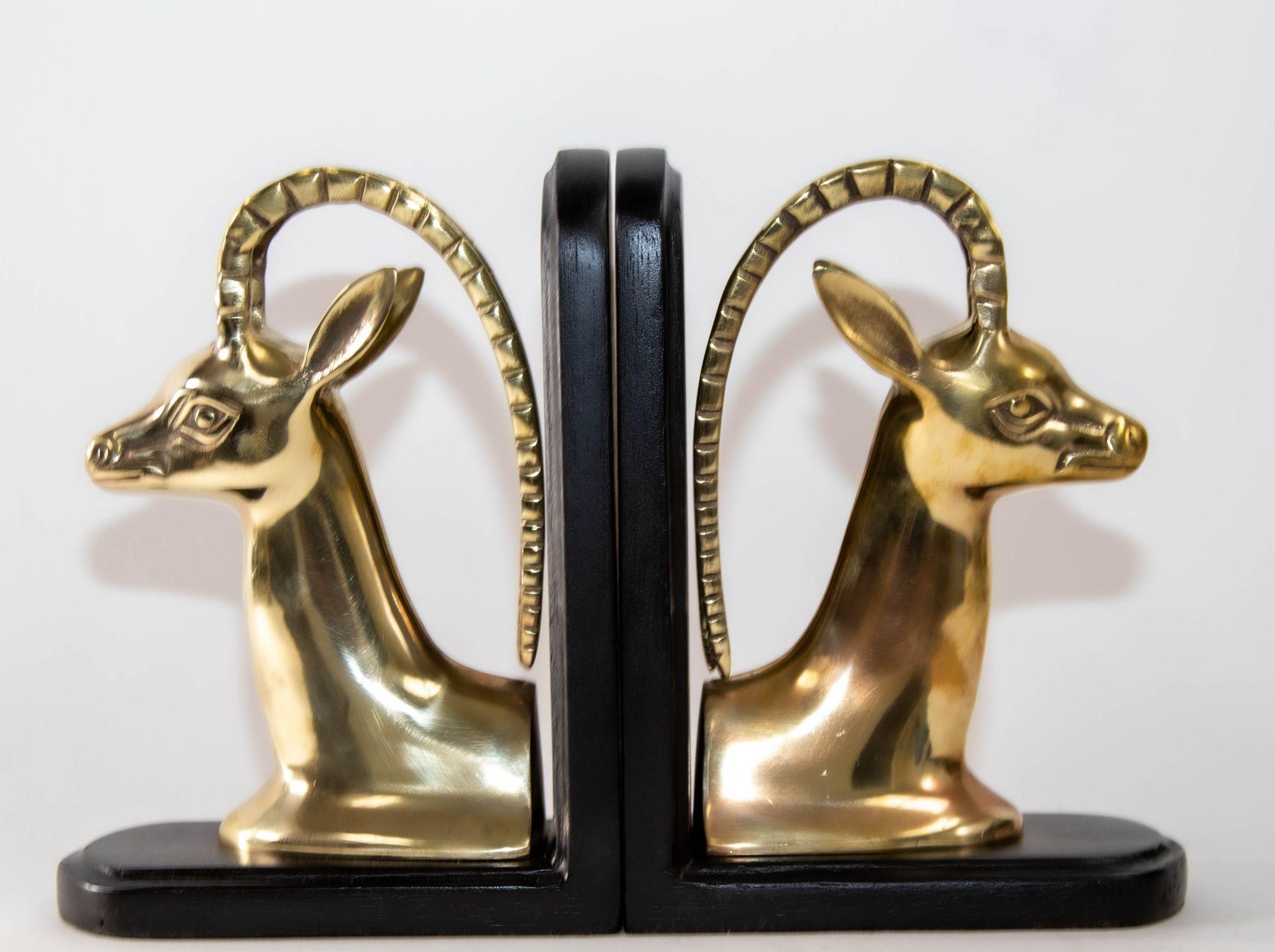 Pair Art Deco Revival Polished Brass Gazelle Mount Bookends.
Exquisite pair of Art Deco Revival antelope gazelle bust sculptures bookends in polished solid brass mounted on black wooden base.
Gazelle Head Hollywood Regency Cast Brass Bookend,