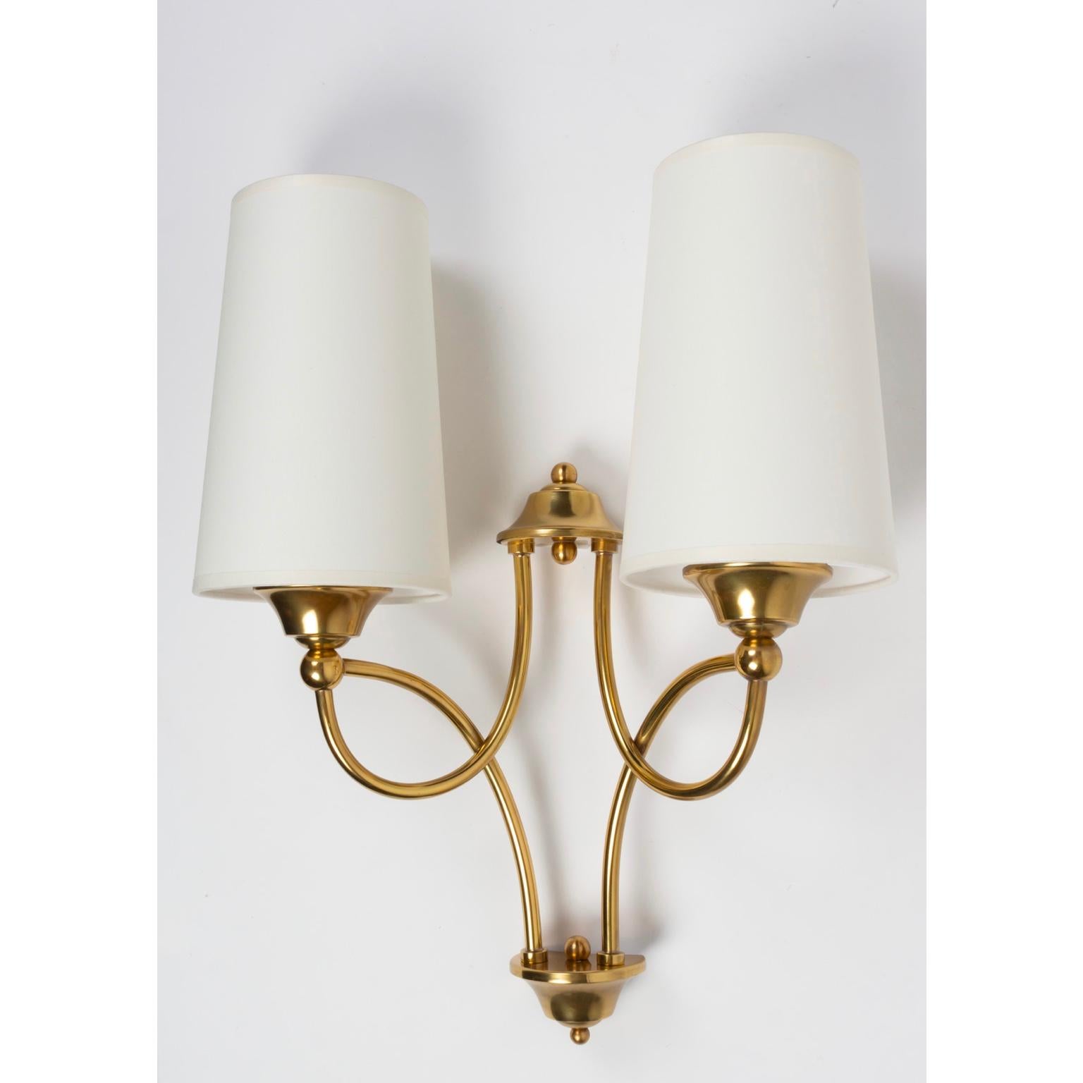Charming pair of Maison Honoré sconces.
Made of brass the sconces feature two lighted arms.
Handmade off-white cotton lampshades.
  