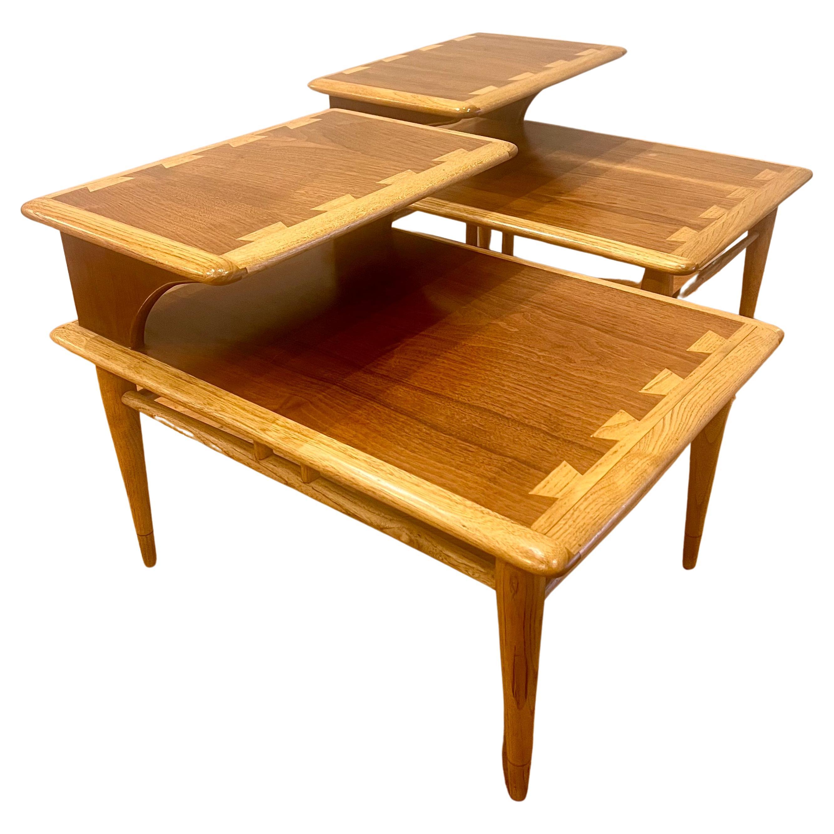 Beautiful craftsmanship on this 1950s, American modern walnut inlaid step end tables, solid tapered legs, and beech wood combination, the tables have been refinished and are in very nice condition. great between 2 club chairs or can be used as a