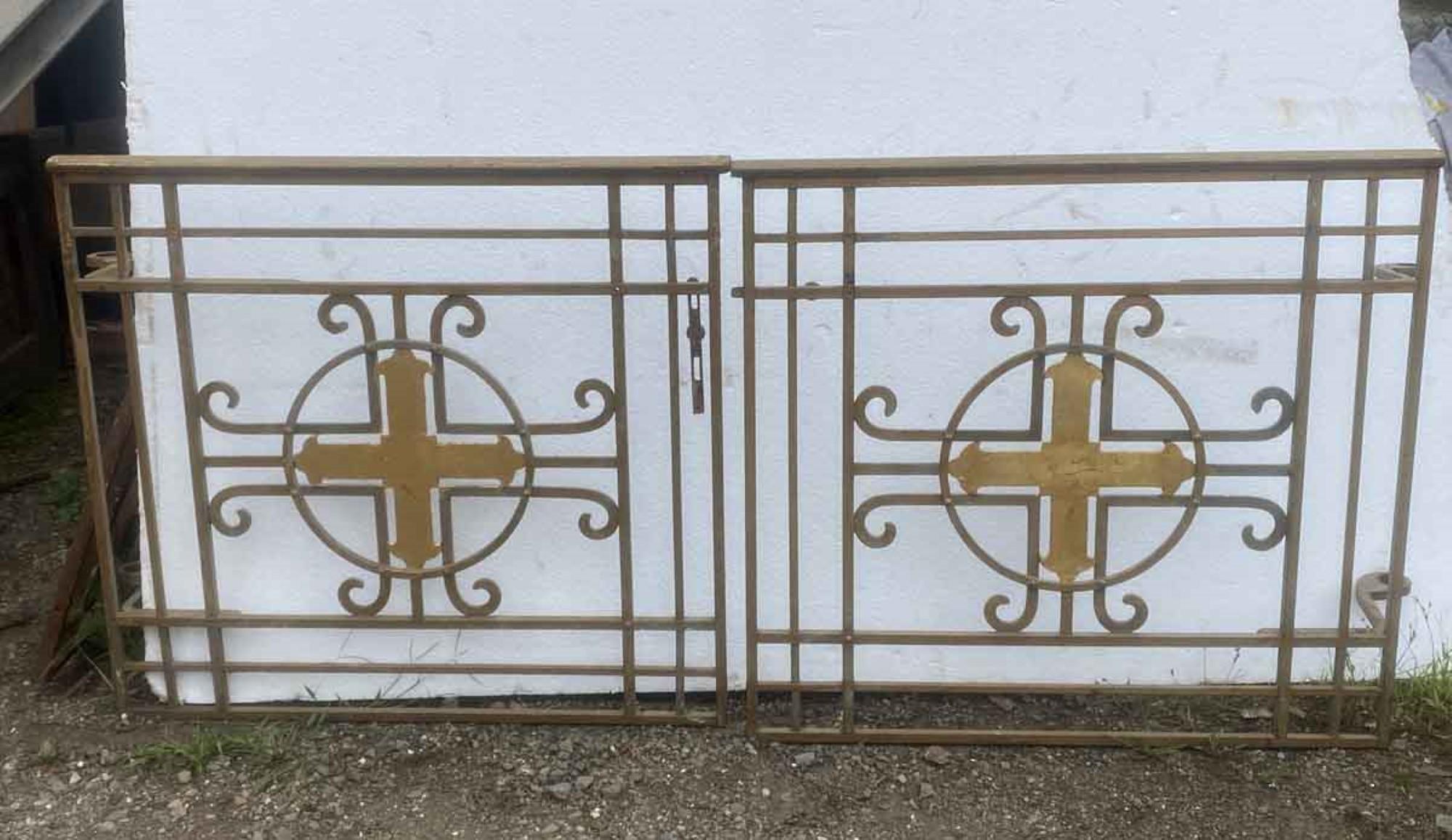 1950s pair of antique solid steel alter gates with a simple ornate cross design. Brass and gold finish. This can be seen at our 400 Gilligan St location in Scranton, PA.