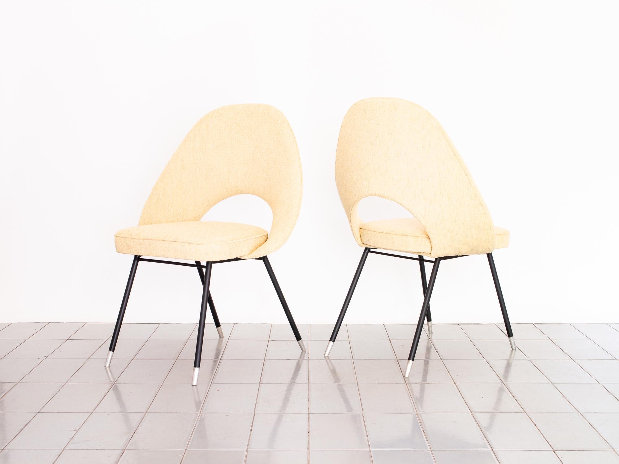 Graceful pair of armchairs upholstered in deliciously soft cream bouclé. Aluminum feet create an interesting effect with the matte black legs.