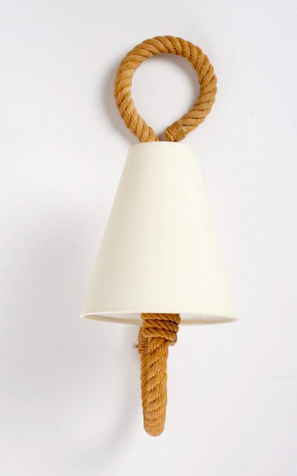 All made of weaved rope the sconces feature one curved arm, ended on the upper part with a buckle. Off-white cotton shades granted to the original. One bulb per sconce.
Adrien Audoux and Frida Minet are known for their lights and furniture made of
